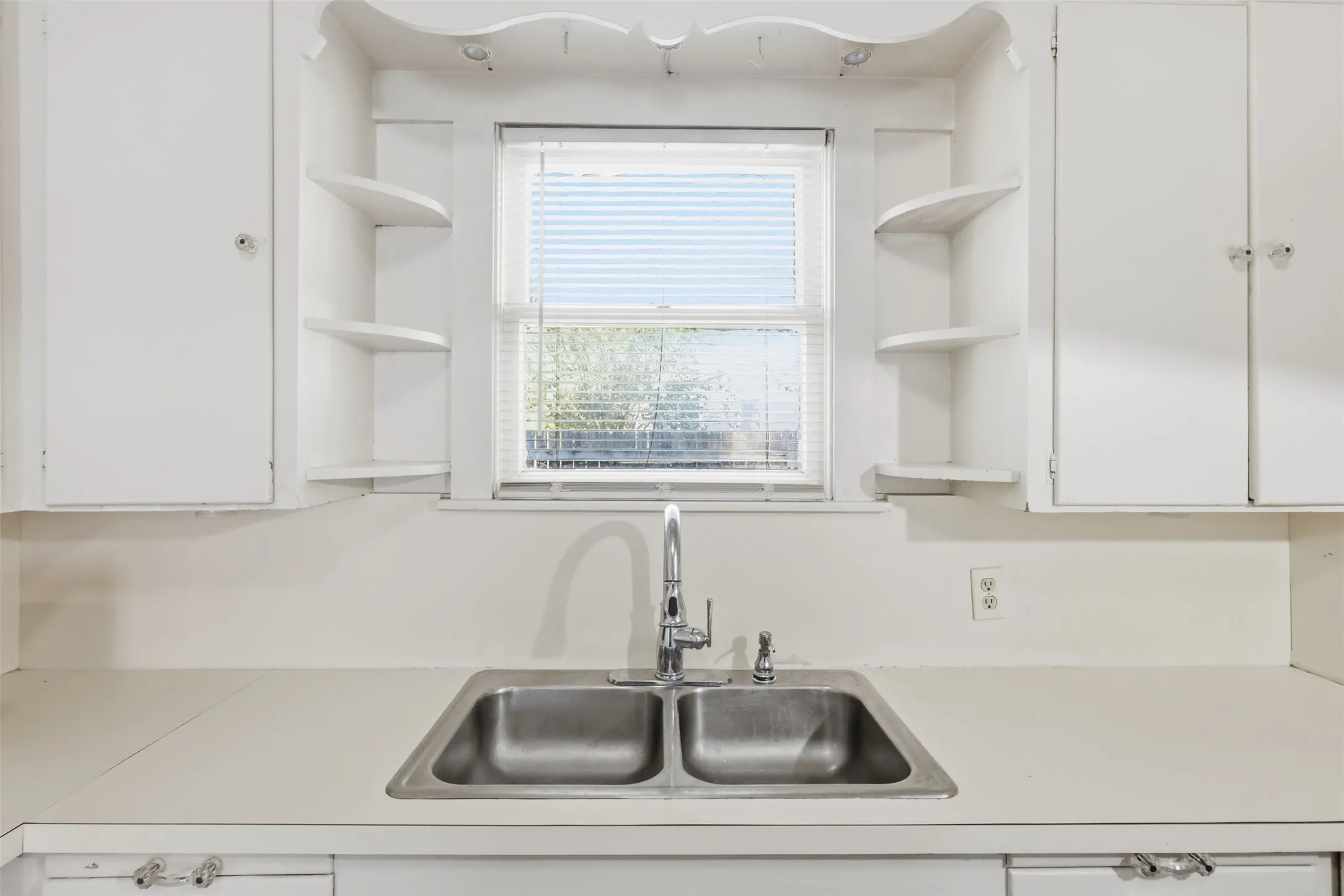 Dual basin stainless steel sink with a chrome faucet