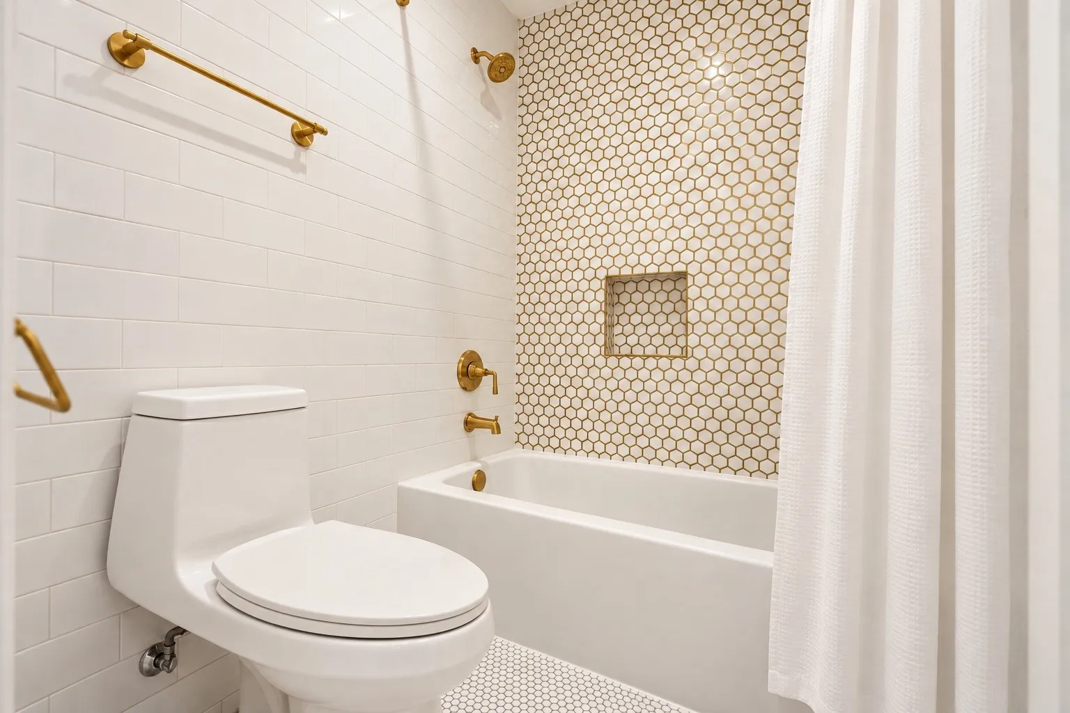 White subway tile walls with gold-tone fixtures