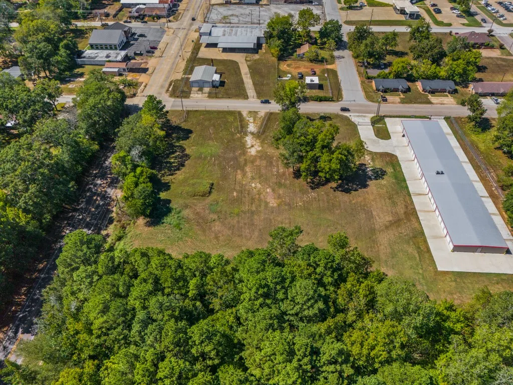 Cleared lot with surrounding mature trees and direct street access