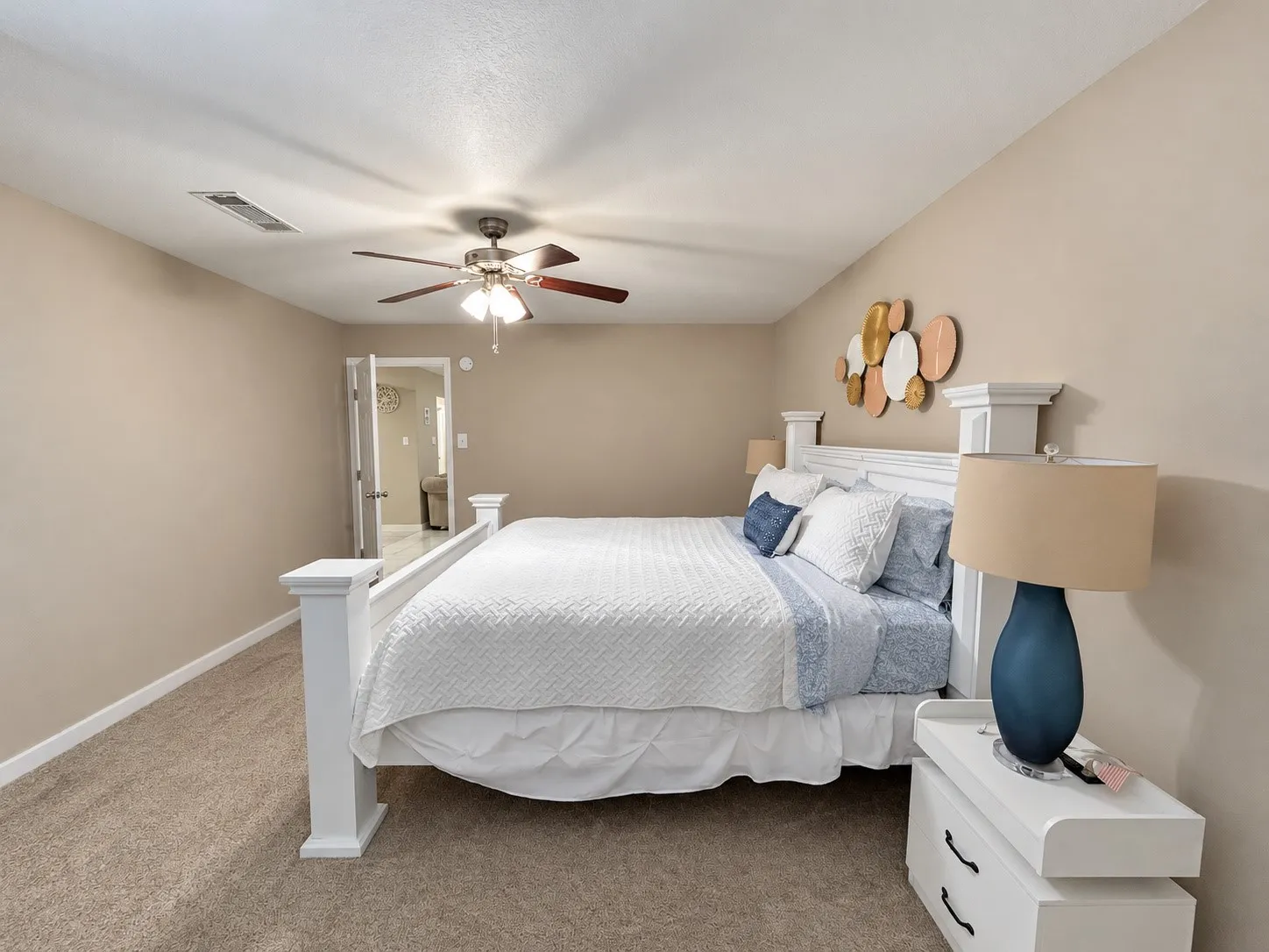 Carpet flooring, neutral wall tones, ceiling fan with integrated lighting, and white trim