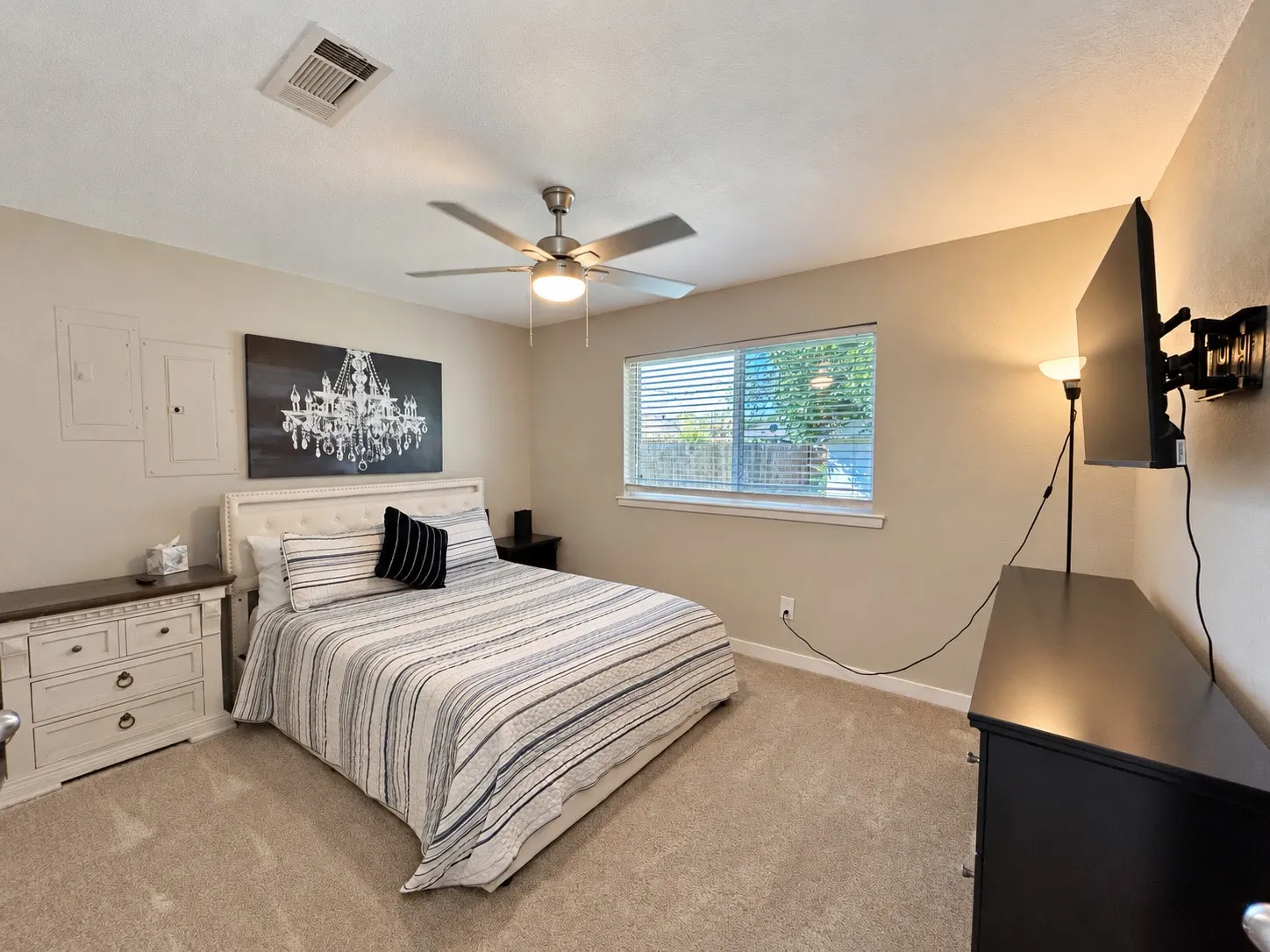 Neutral-toned walls, carpeting, and a window with blinds