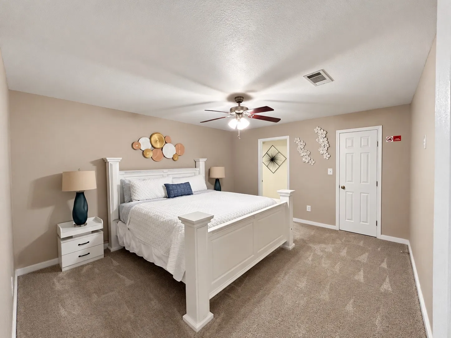 Neutral-toned walls complement plush carpeting