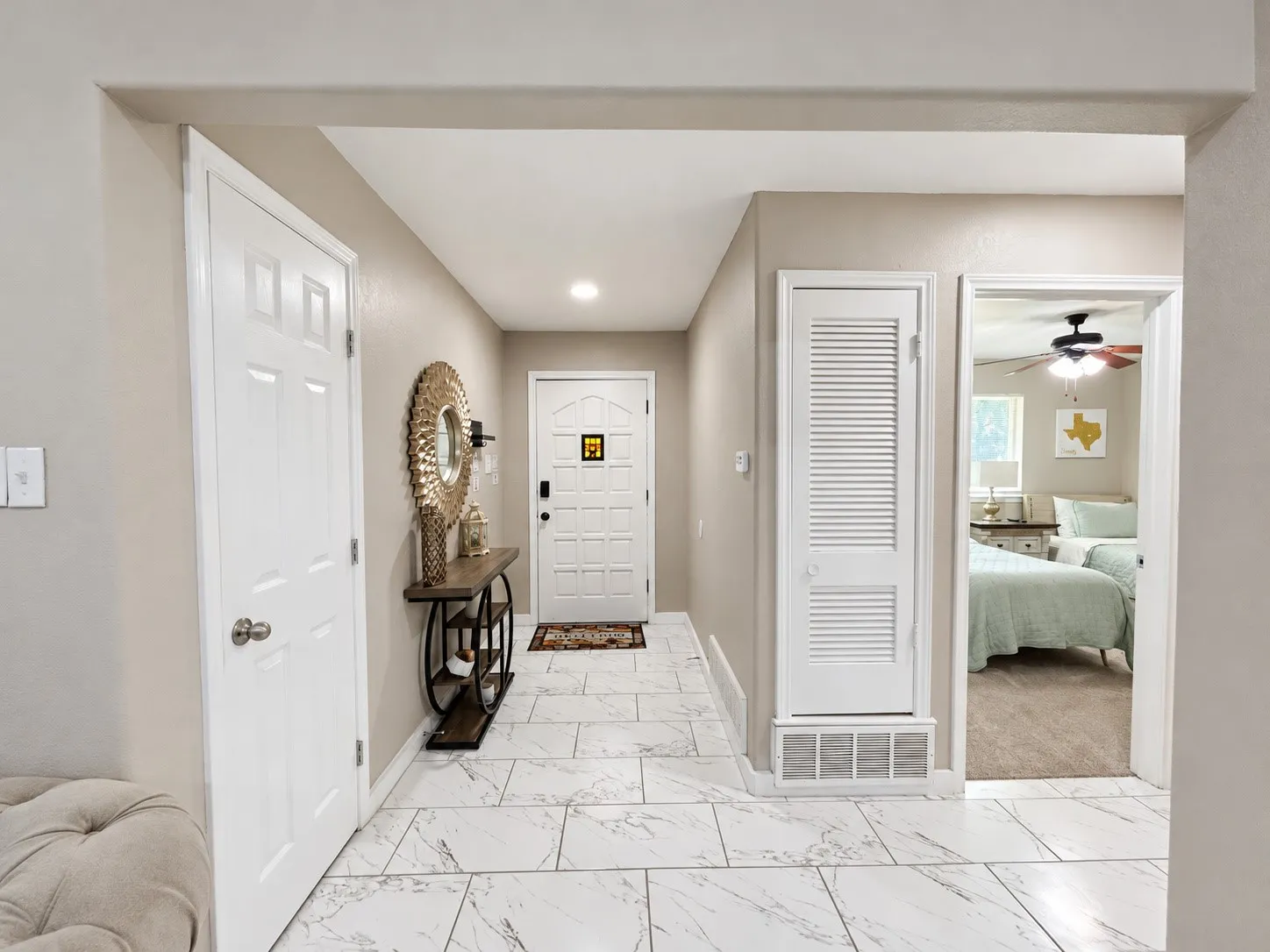 Entryway featuring white tile flooring, recessed lighting, and a paneled entry door