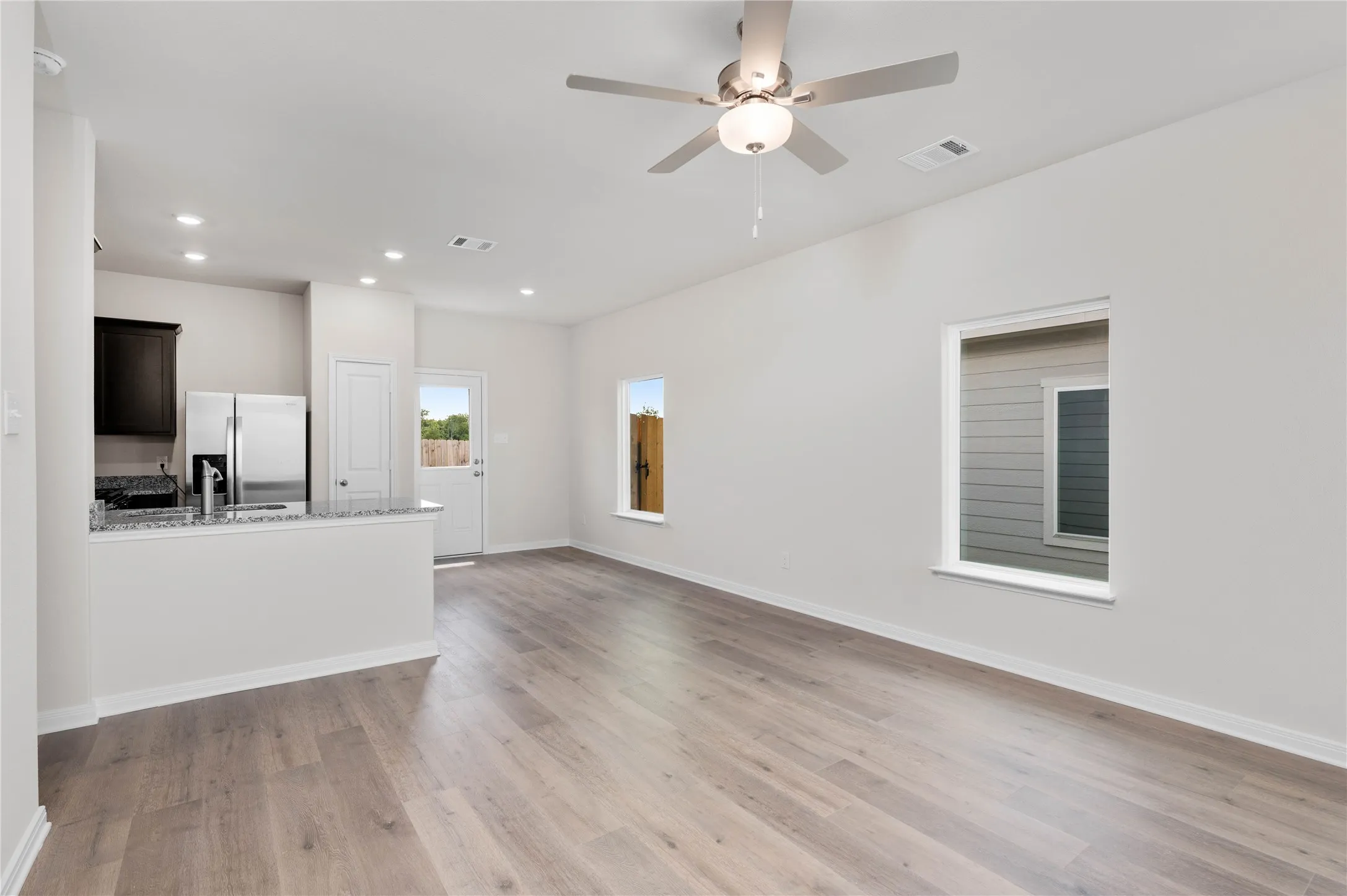 Unfurnished living room with light wood finished floors, recessed lighting, and ceiling fan