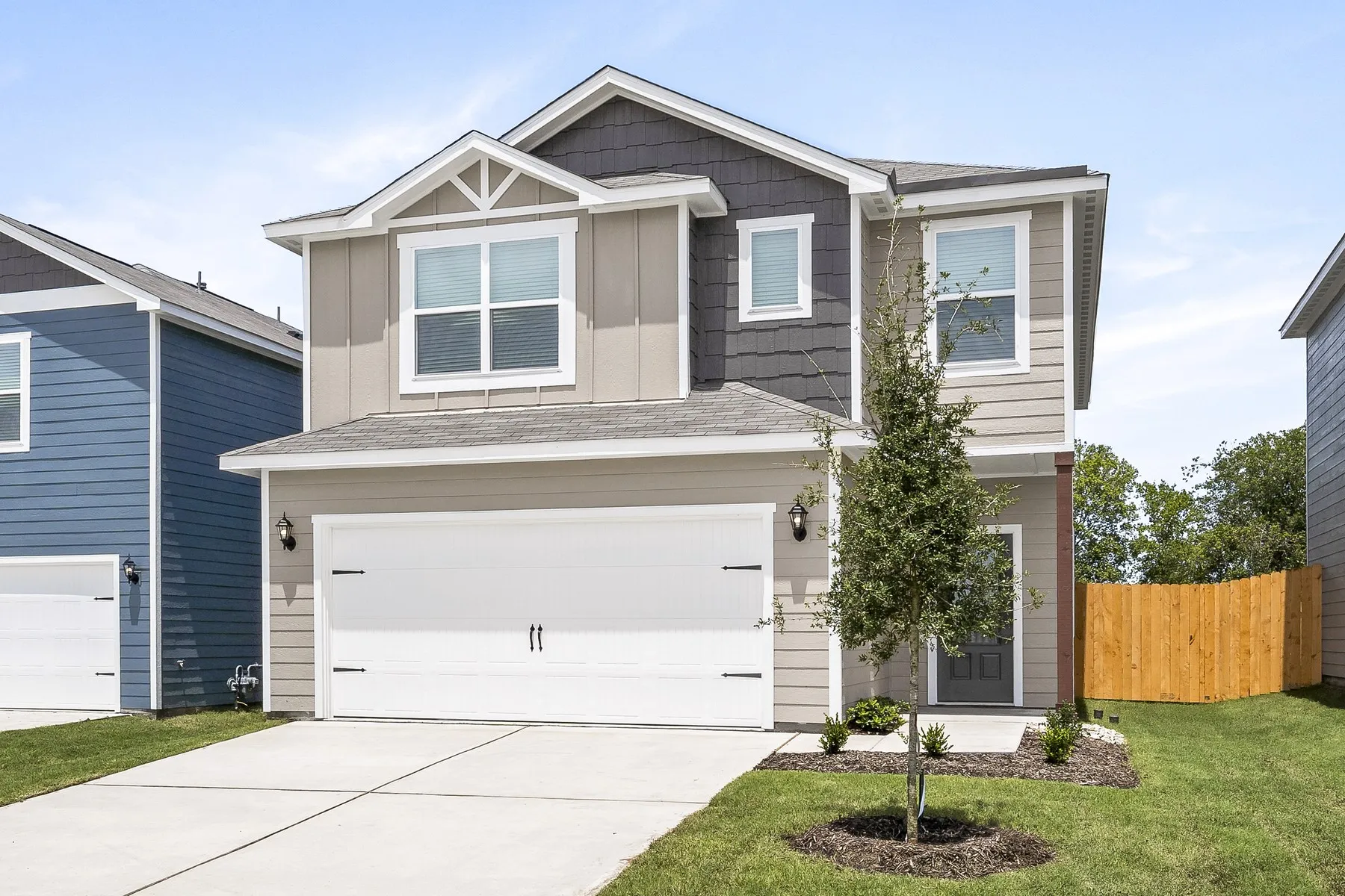 View of front of home with a garage and a front lawn
