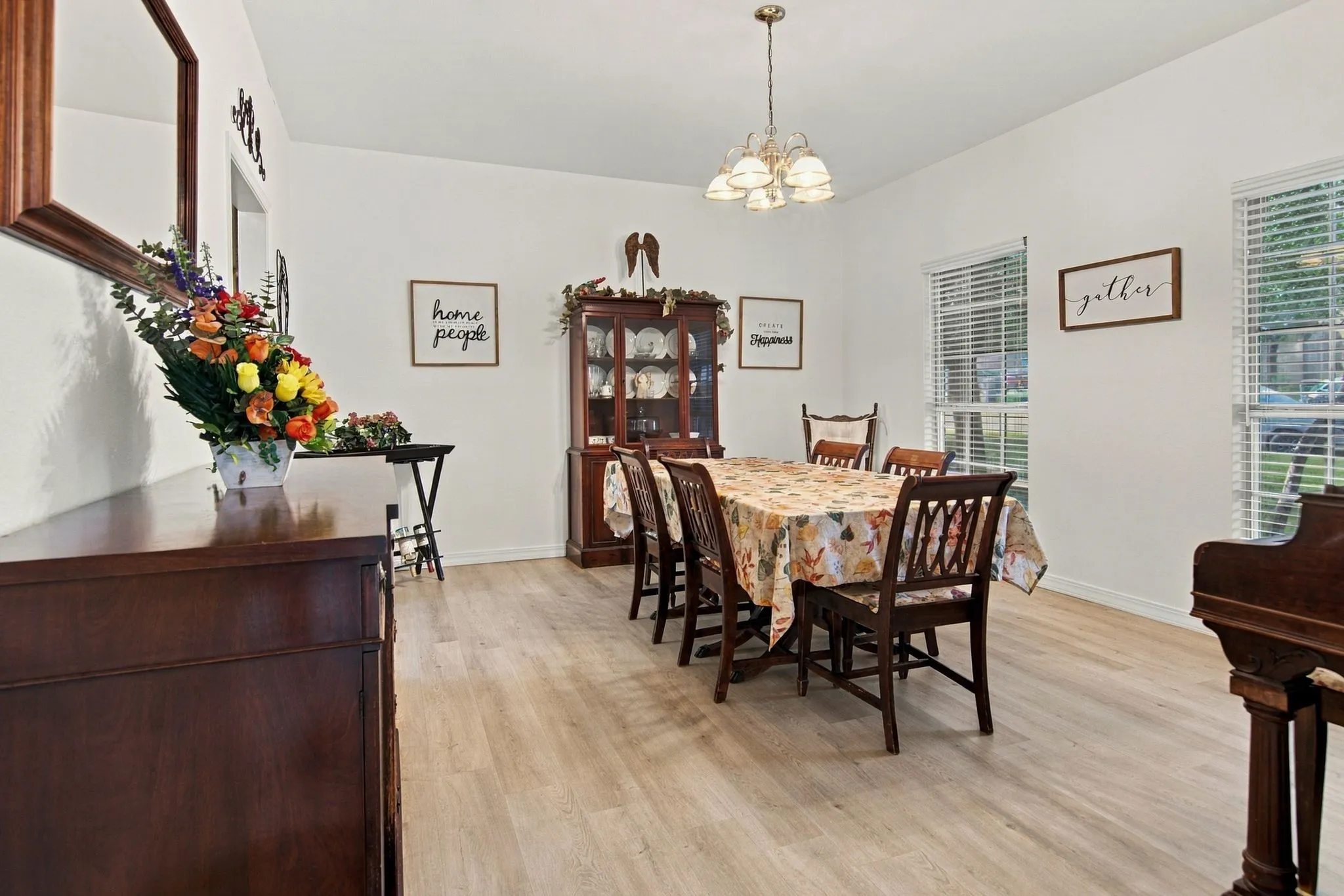 Recessed lighting, wood-finish flooring, and multiple windows with blinds