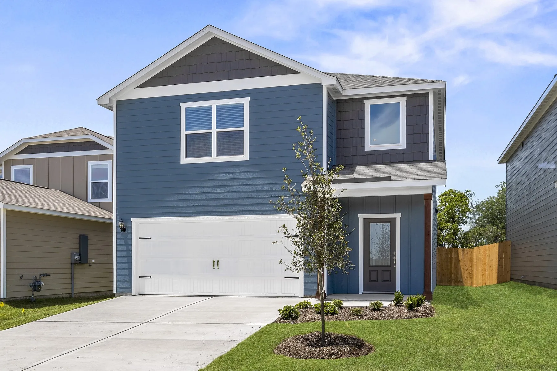 View of front of property with a garage, driveway, and roof with shingles