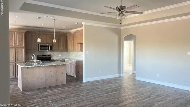 Kitchen featuring light wood-finish cabinetry, granite countertops, and stainless steel appliances