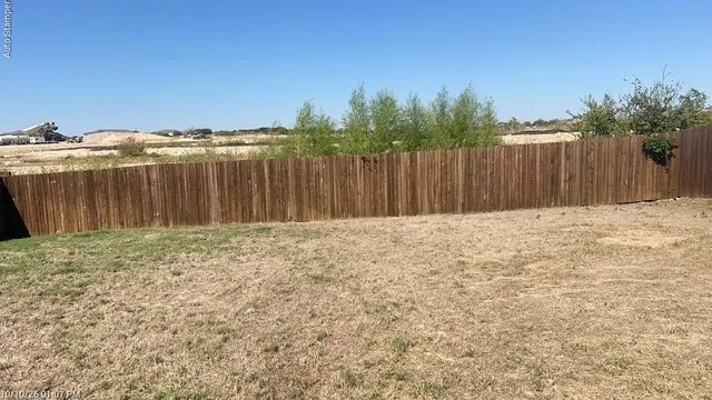 Private backyard featuring a wood privacy fence