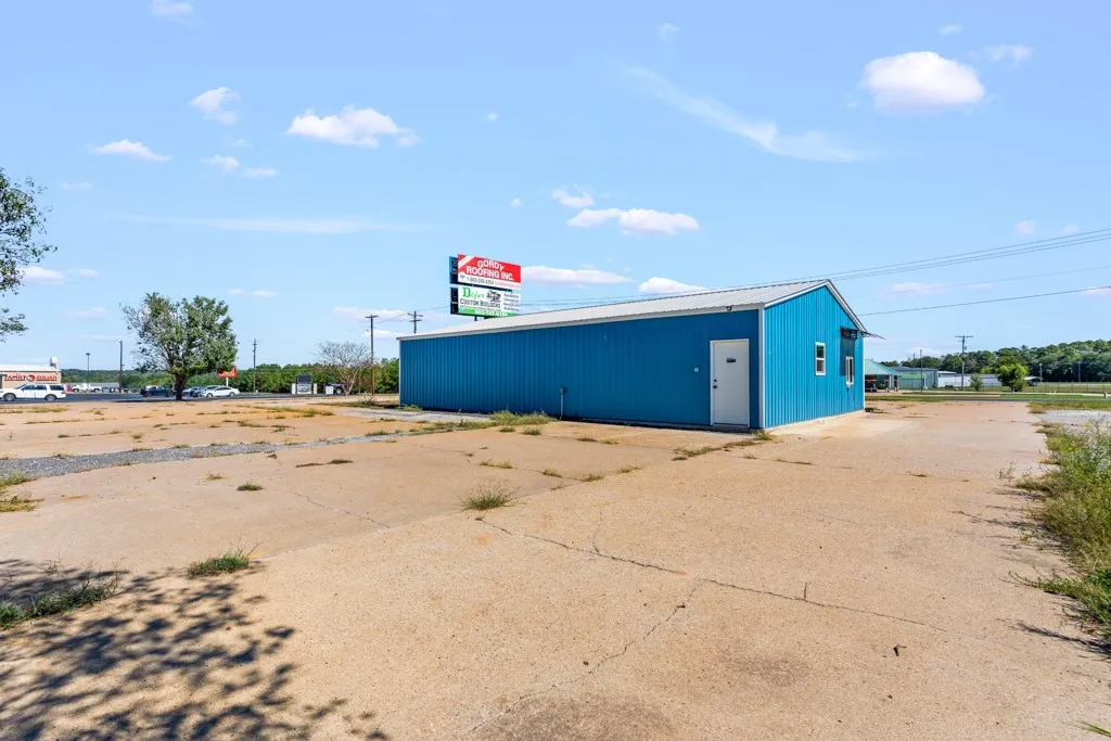 Freestanding commercial building with blue siding and a white door