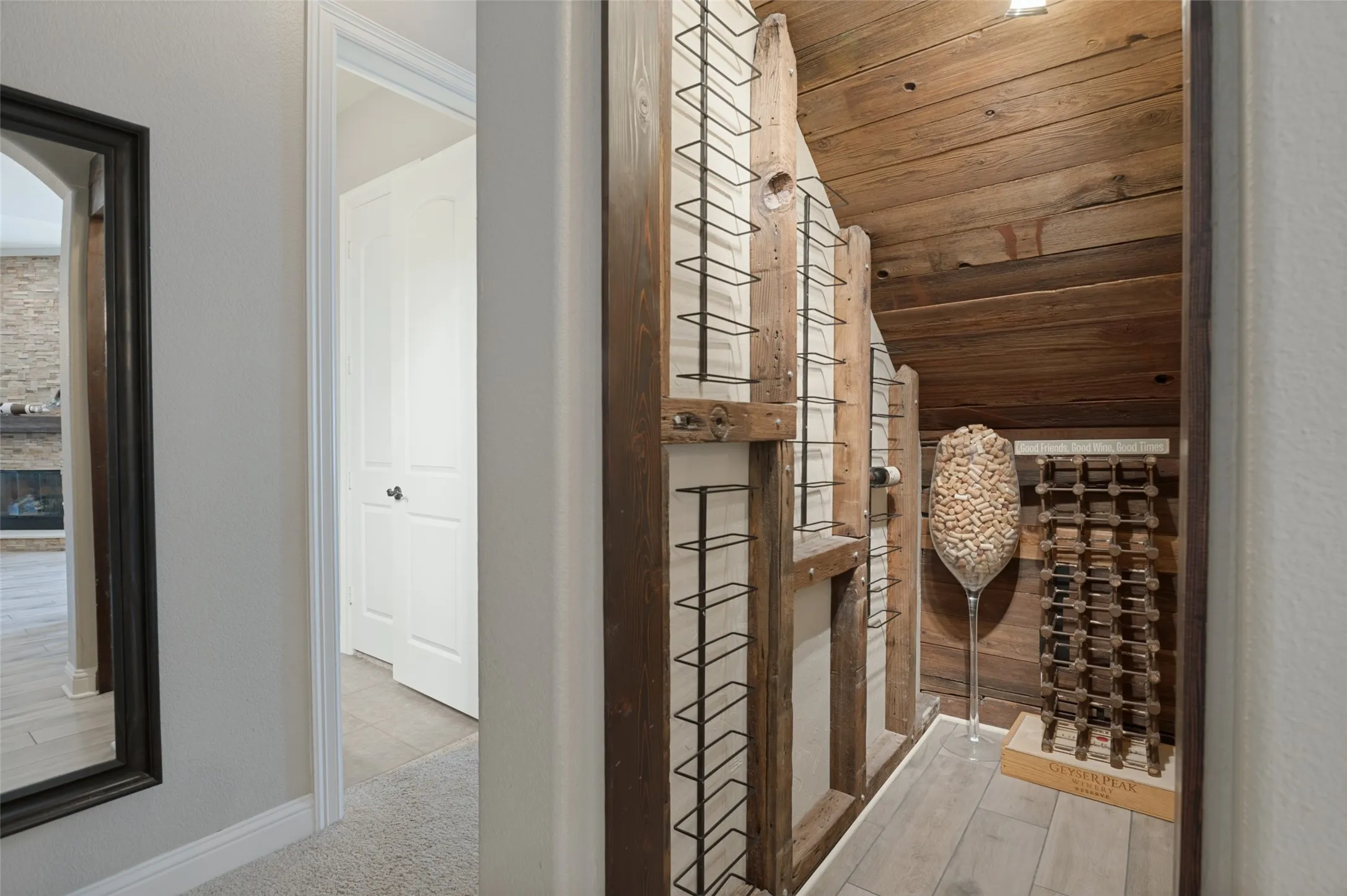 Custom wine storage with wood plank walls and wood-finish flooring