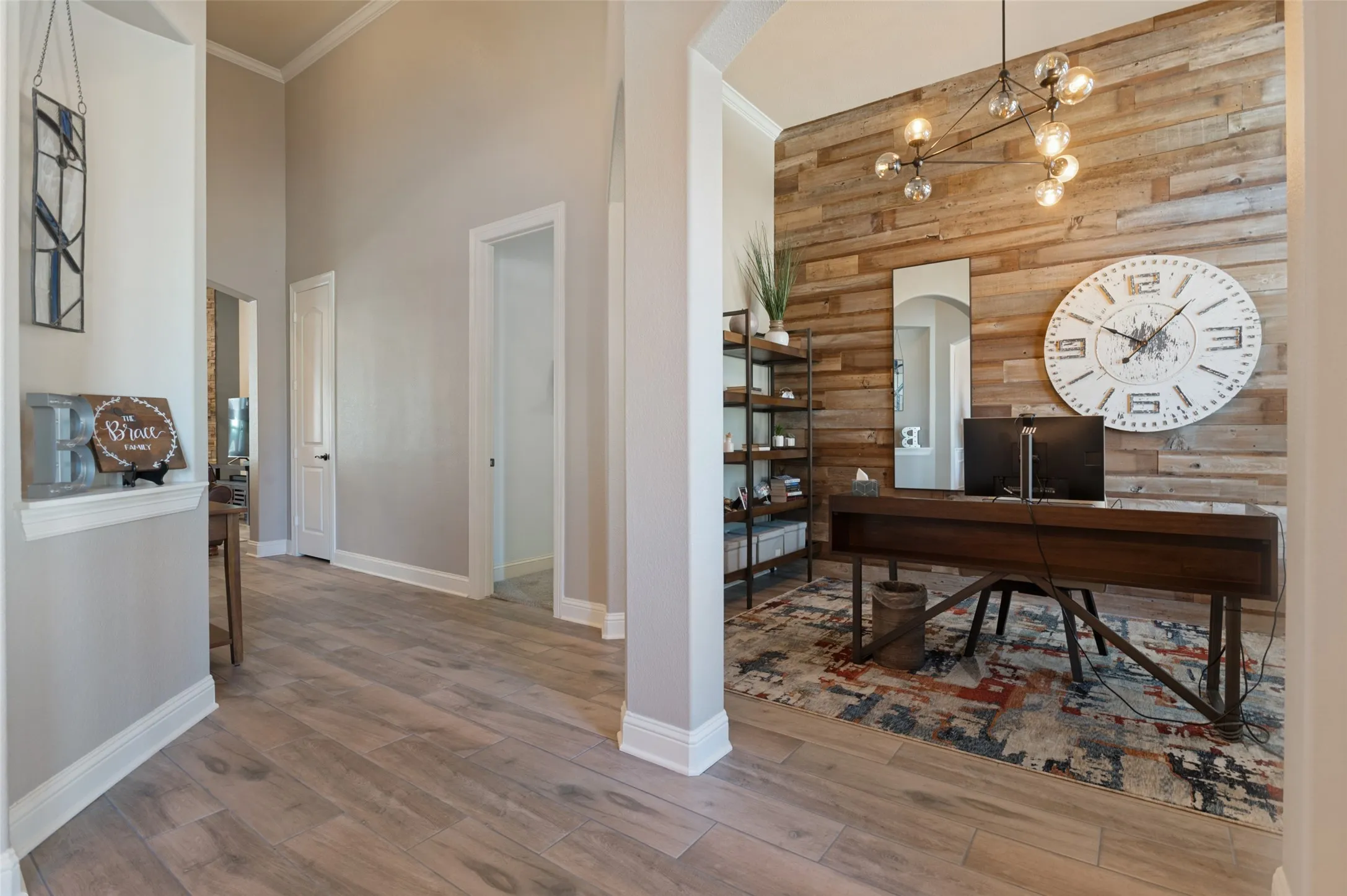 Wood-finish flooring throughout, with crown molding and high ceilings