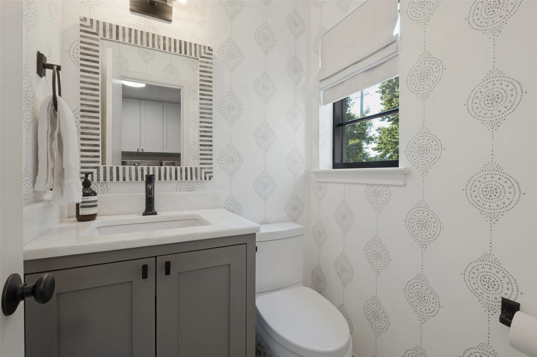Separate stylish powder bath off utility room.