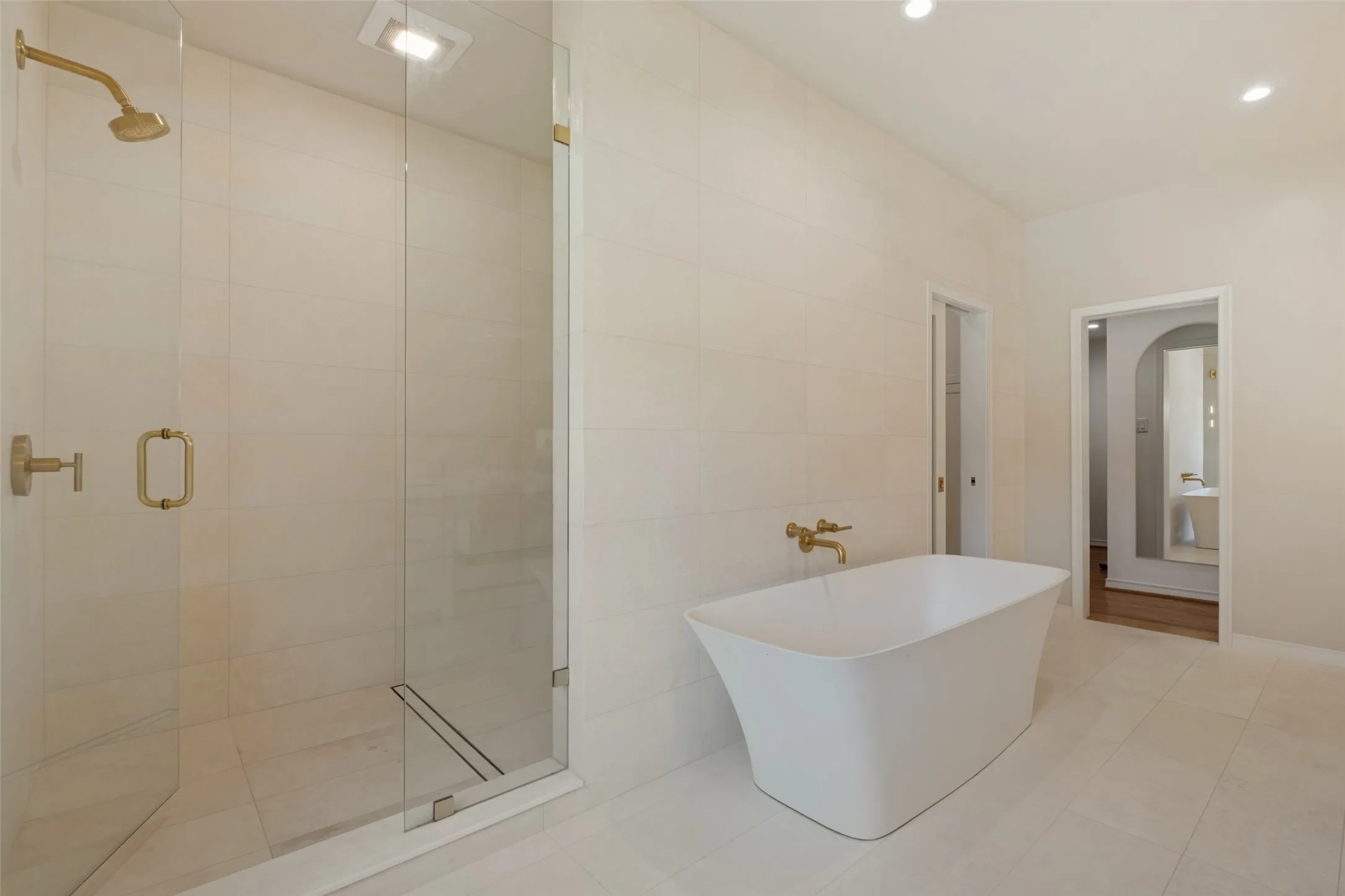 Oversized walk-in shower with double shower heads.
