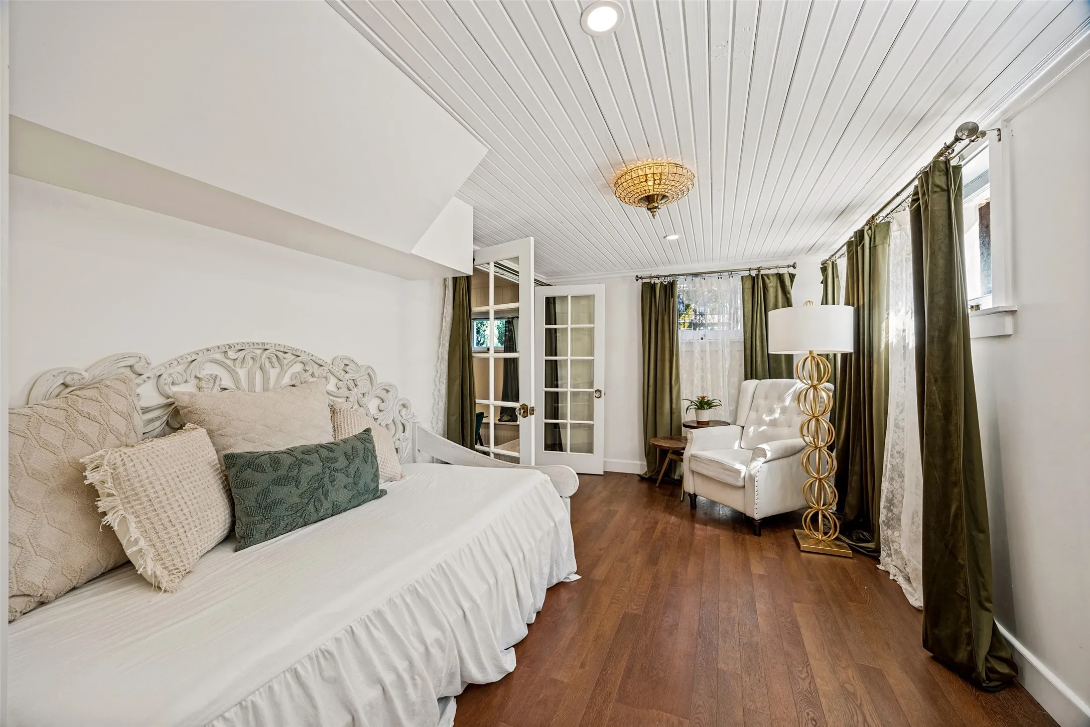 Wood-finish flooring, white paneled ceiling with recessed lighting, and a decorative ceiling fixture