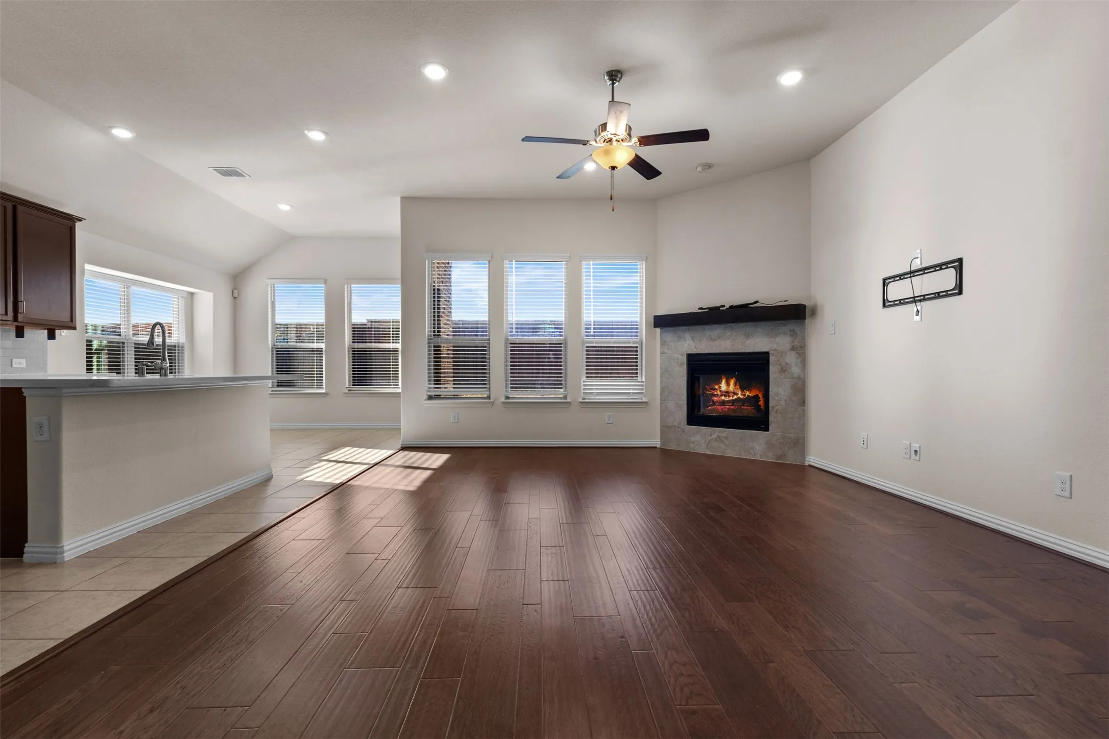 Hardwood-style flooring throughout, vaulted ceiling, and recessed lighting