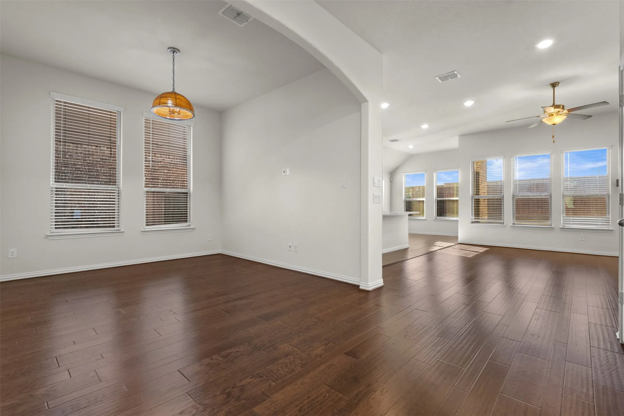 Wood-finish flooring throughout, with a decorative pendant light fixture and recessed ceiling lighting
