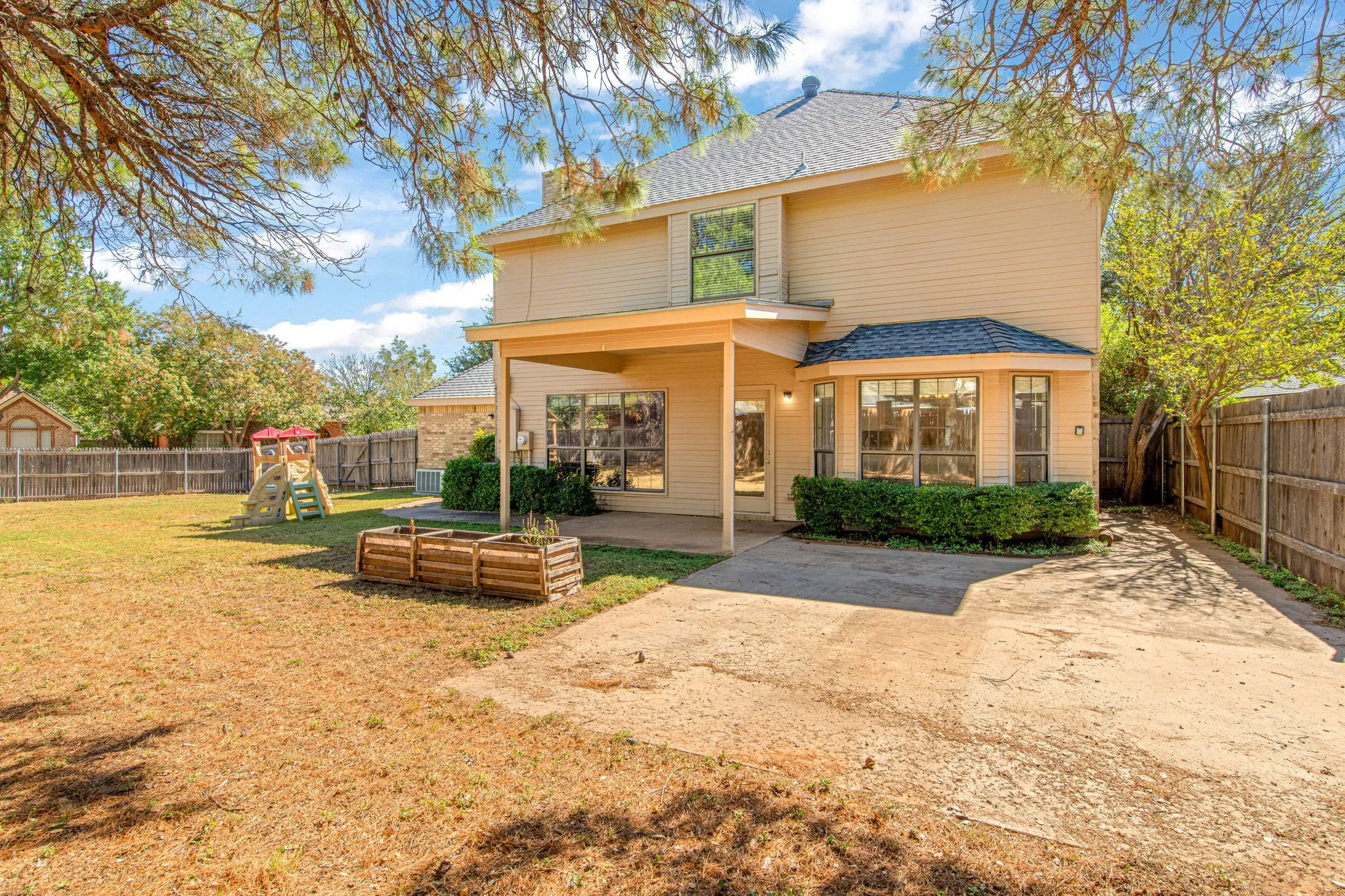 Back of home with large back yard situated on a cul de sac corner lot.