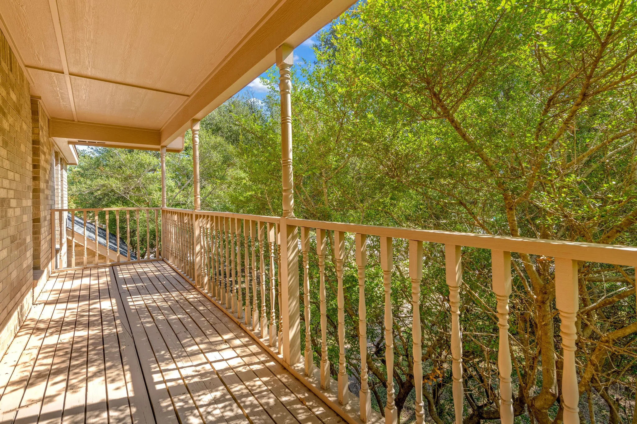Secluded by mature towering oak trees.  Private balcony located off primary bedroom above front entry porch.