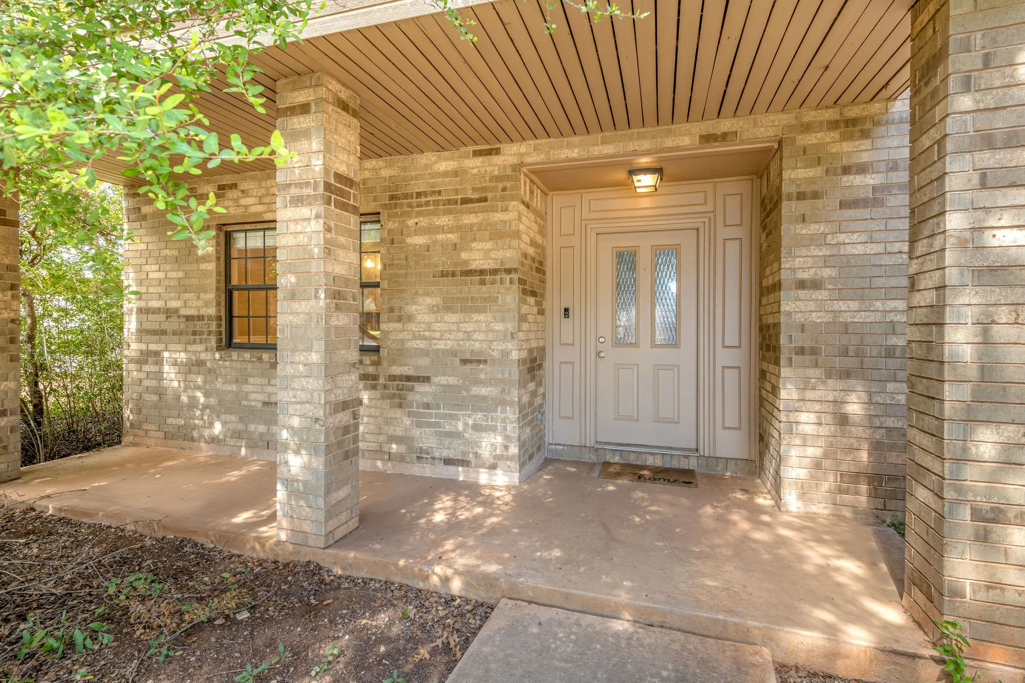 Brick home with great covered front porch accented with brick columns.