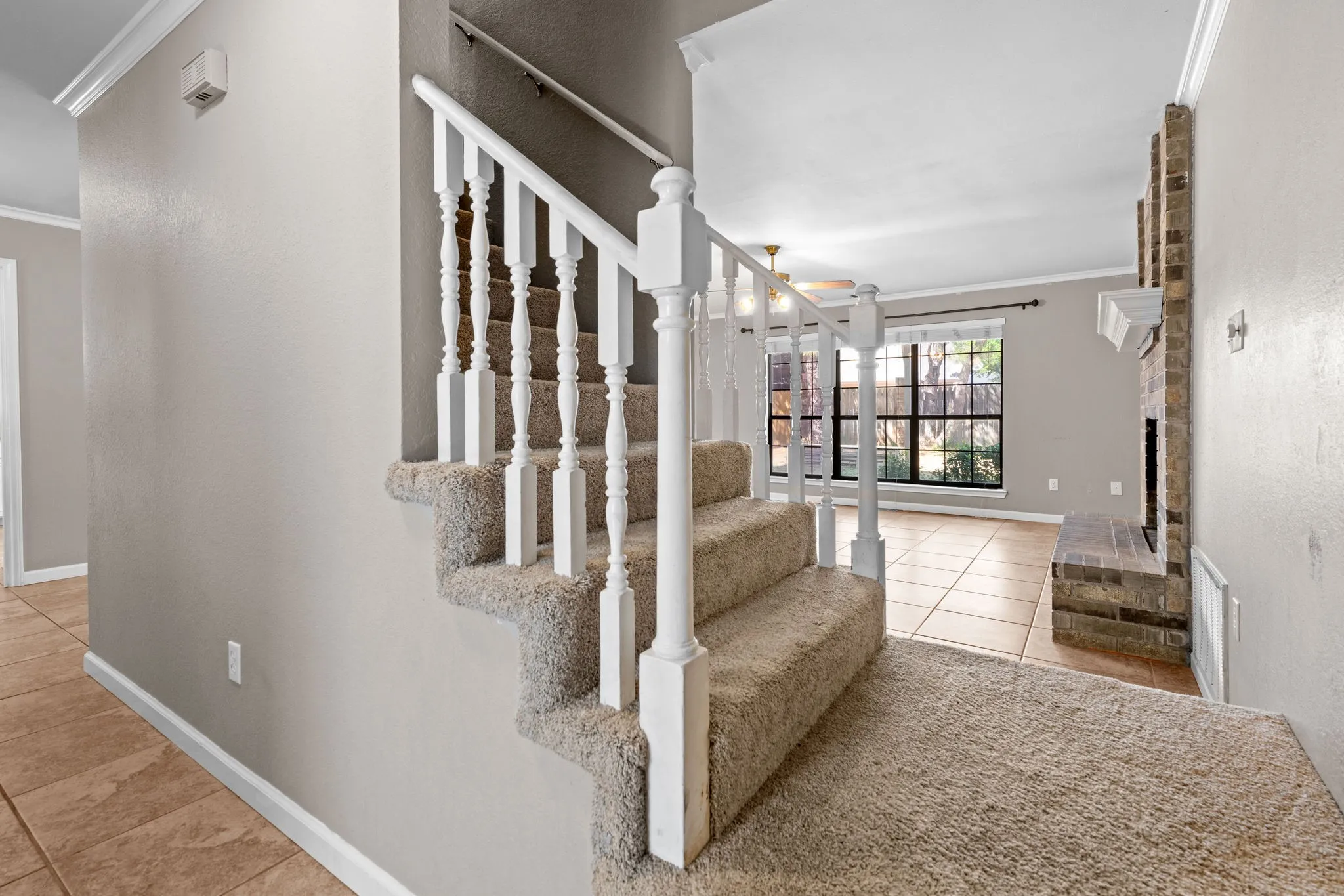 Stairway up to second floor accessible both from hallway and living room.