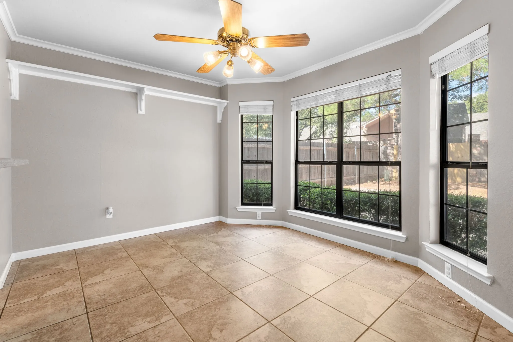 Breakfast area with view to private back yard and display shelf.