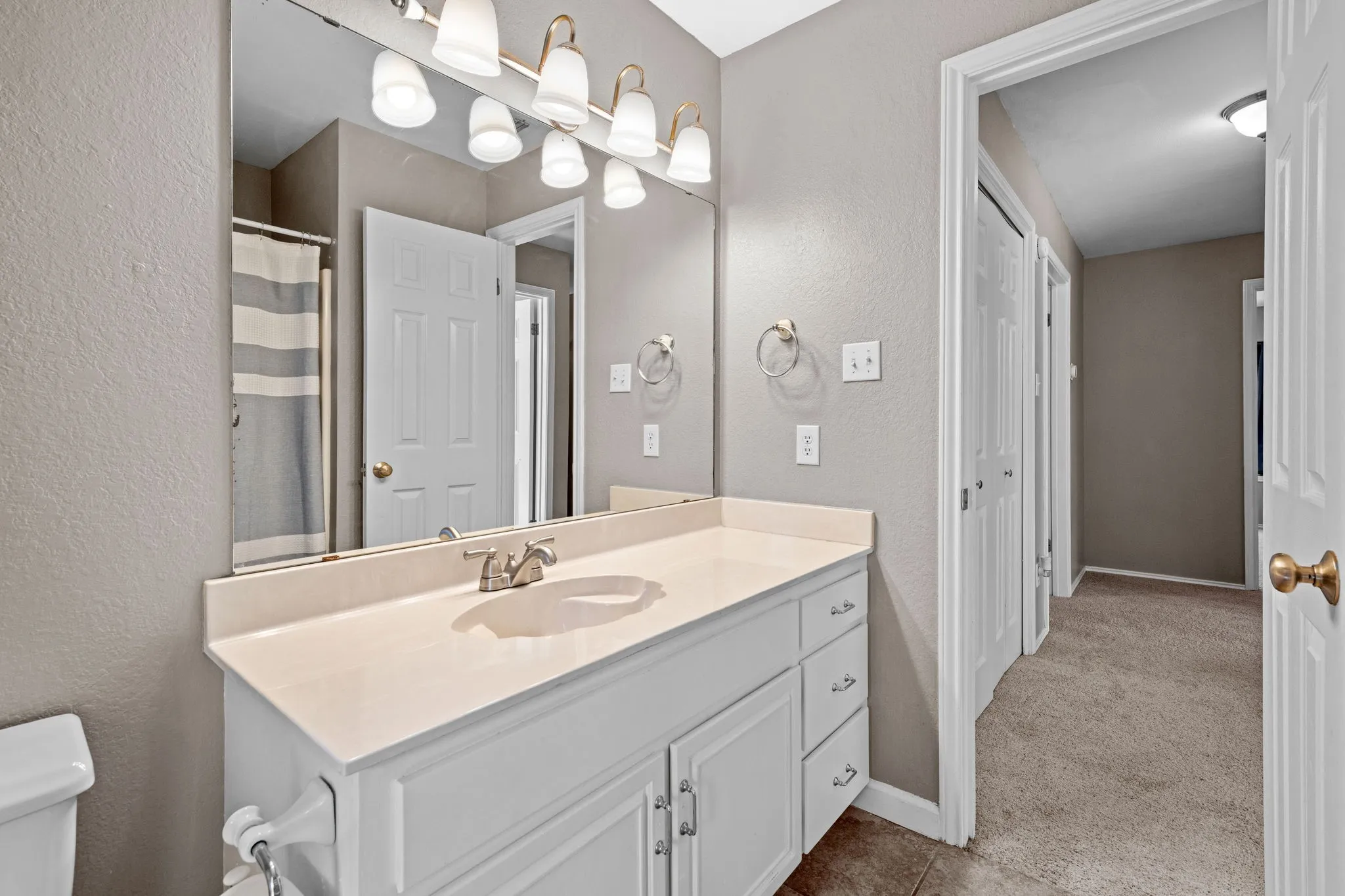 Full bathroom upstairs conveniently serves three additional bedrooms.