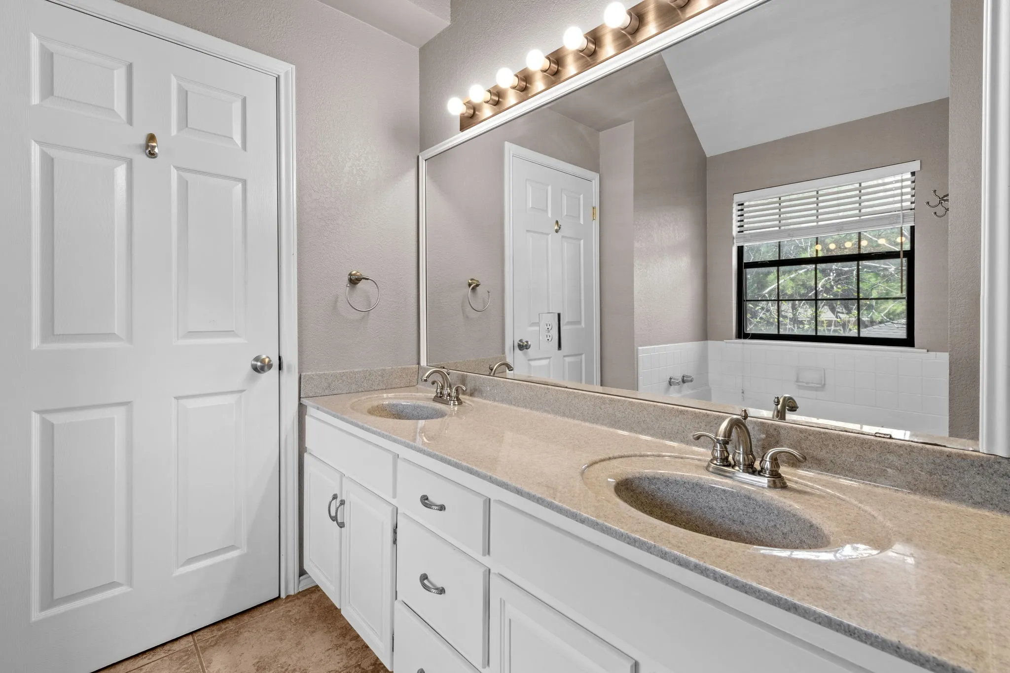 Primary bathroom with walk in closet and double sinks.