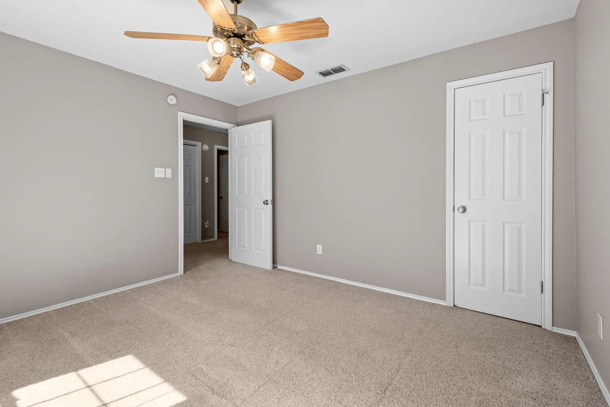 Front bedroom with ceiling fan and closet.