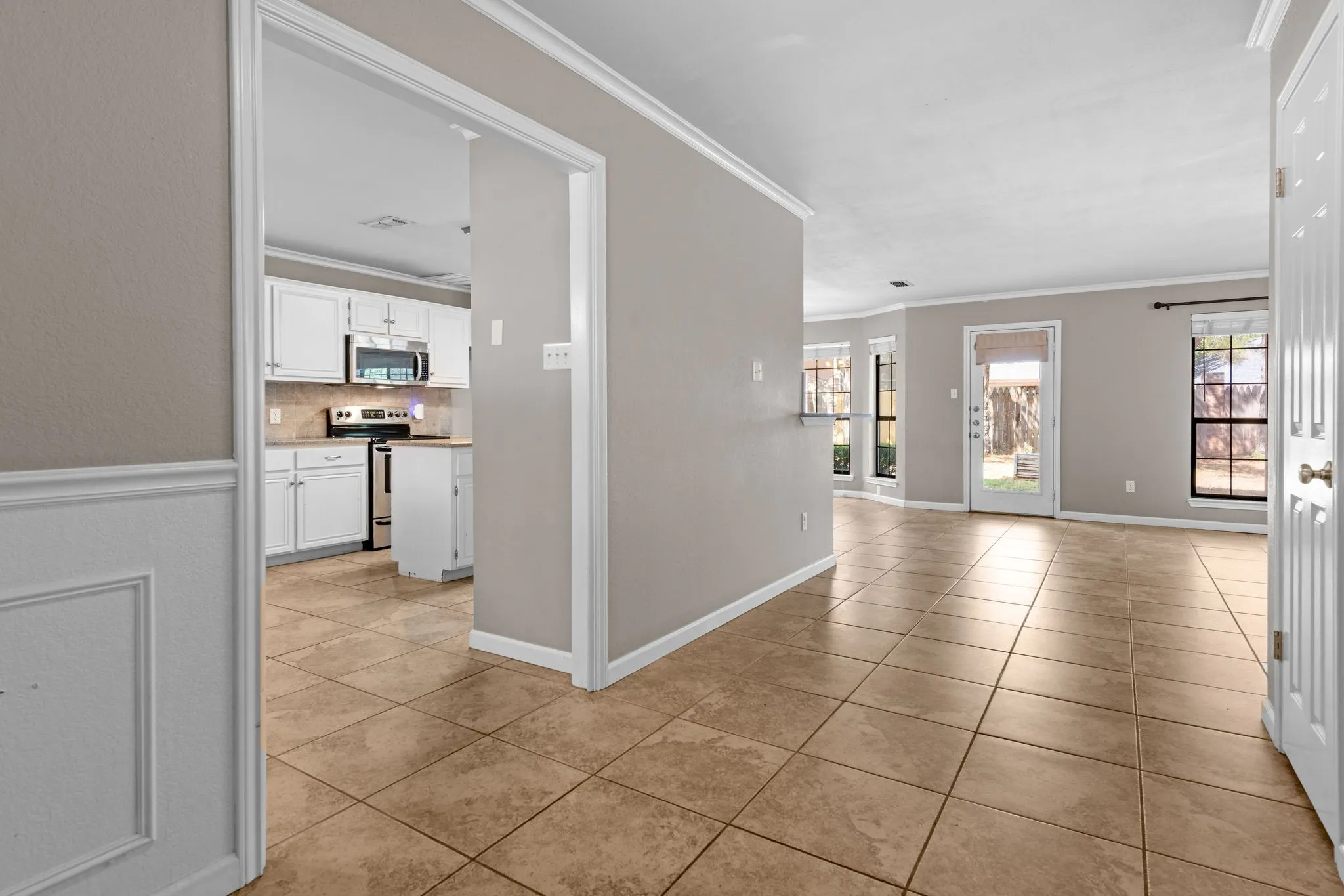 Entry with view to kitchen to the left and living room off to the left.