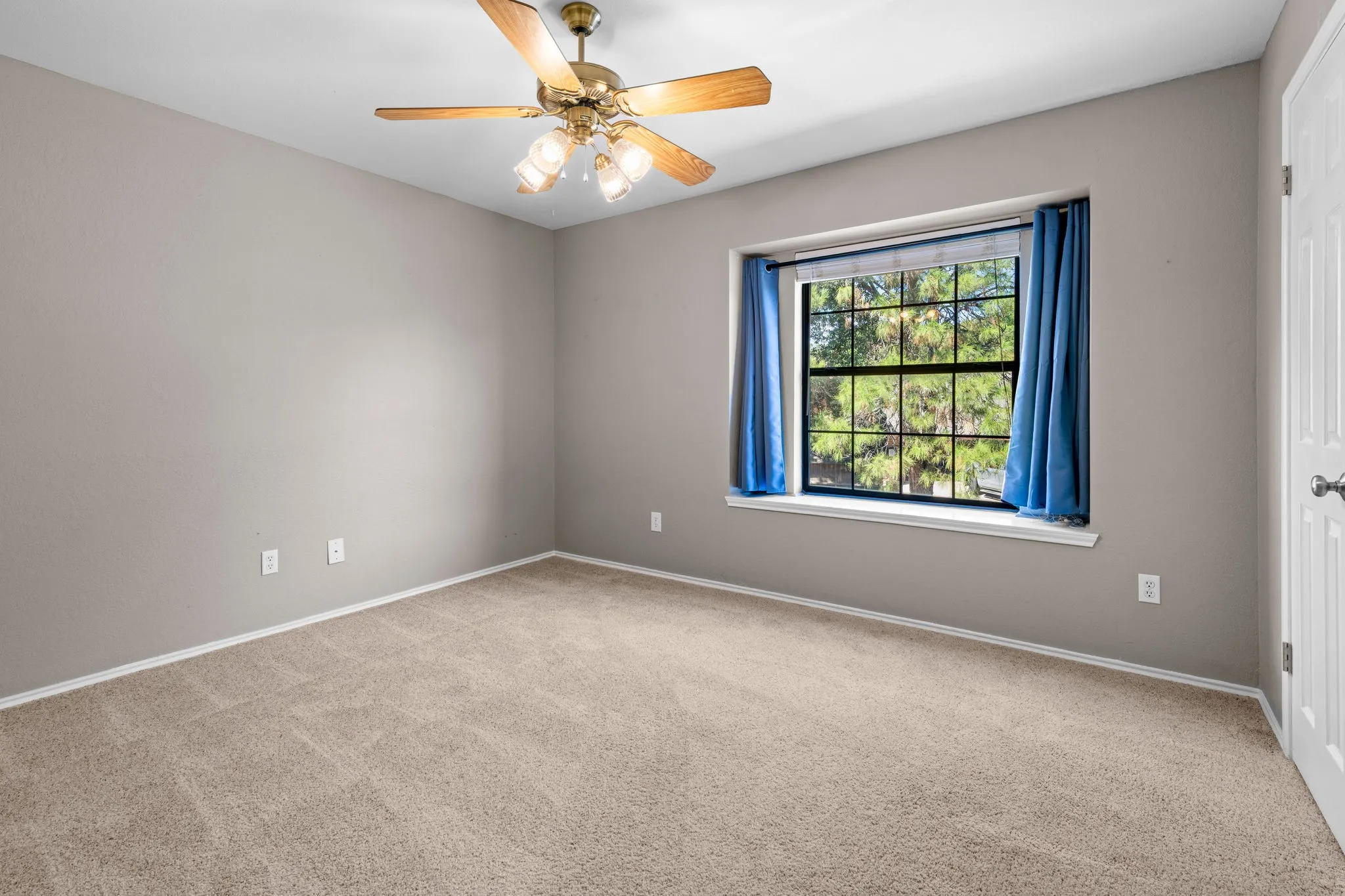 Back bedroom with ceiling fan and closet overlooks the large back yard.