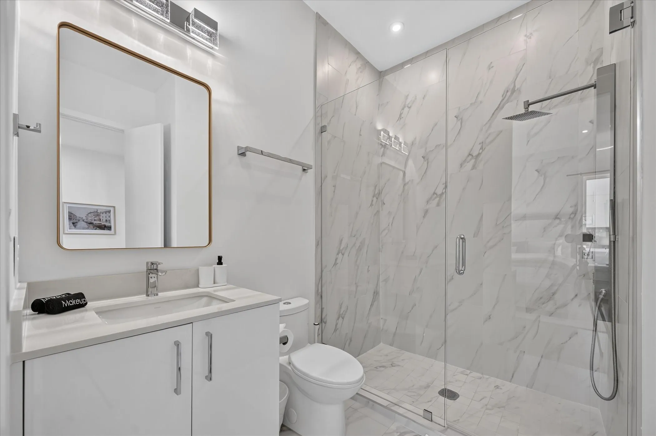 Vanity with a quartz countertop, rectangular undermount sink, and chrome faucet
