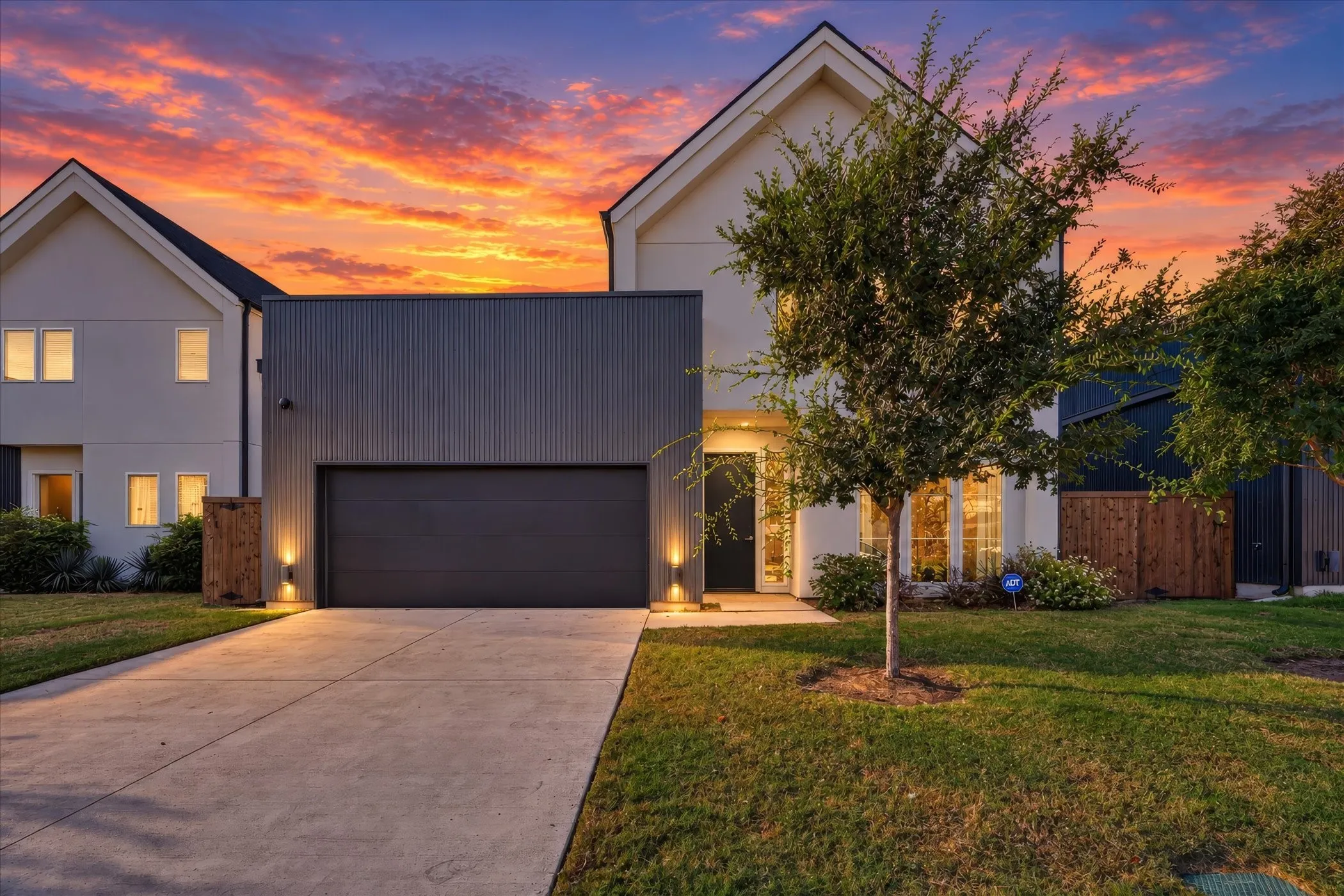 Contemporary exterior with a white facade and dark gray corrugated metal accents