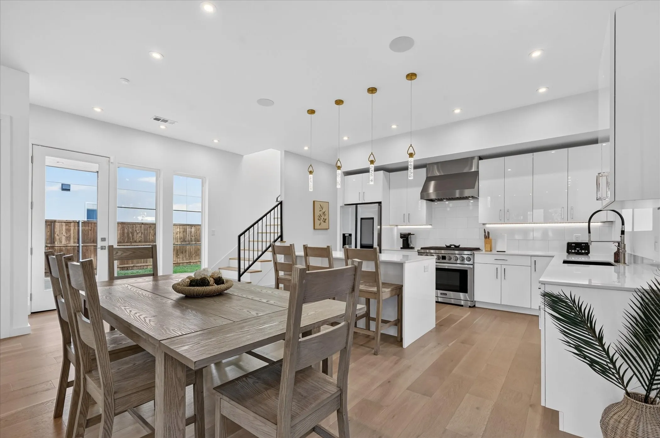 Gleaming kitchen with white cabinetry and stainless steel appliances