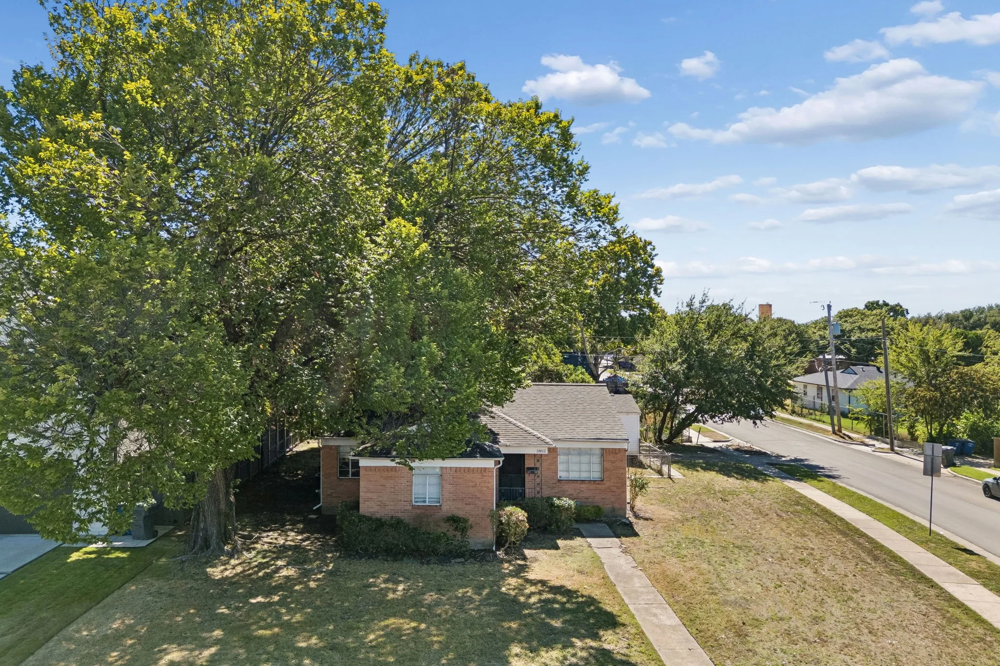 Aerial view looking south.Road is Mixon. Beautiful fully mature tree at perimeter.