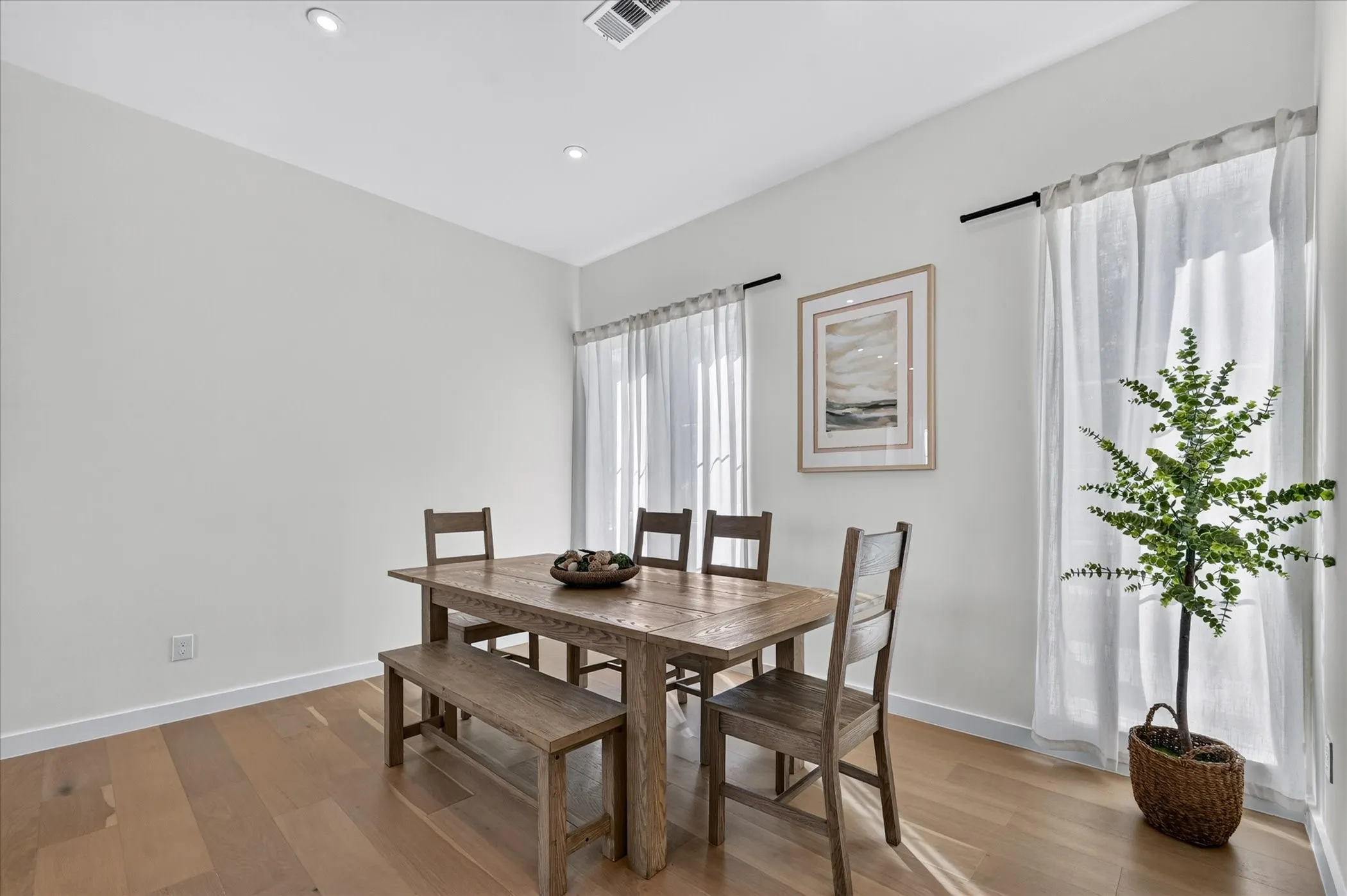 Recessed lighting illuminates wood-finish flooring