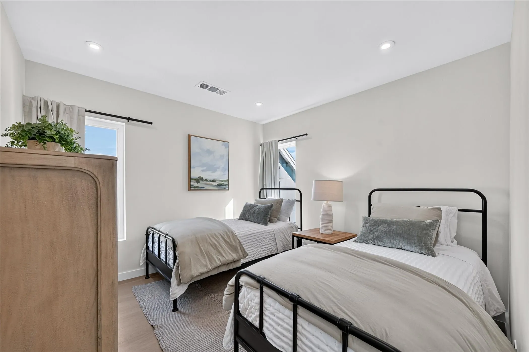 Recessed lighting, wood-finish flooring, and white walls