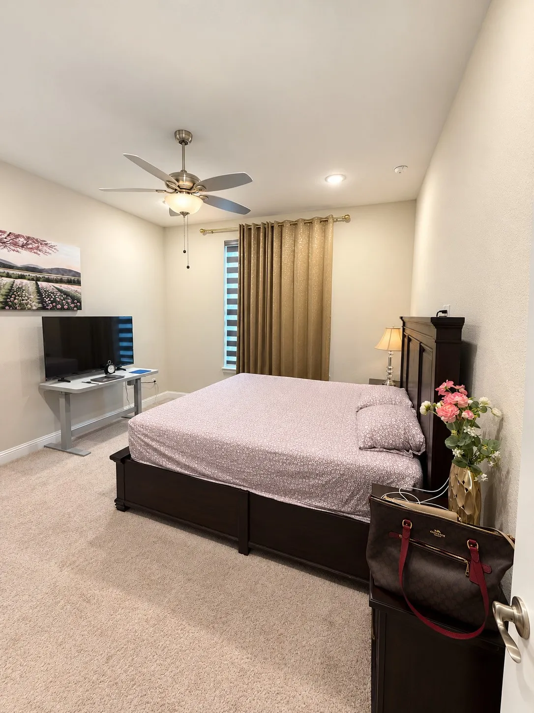 Carpeted flooring throughout, featuring a ceiling fan with integrated lighting, recessed lighting, and window treatments