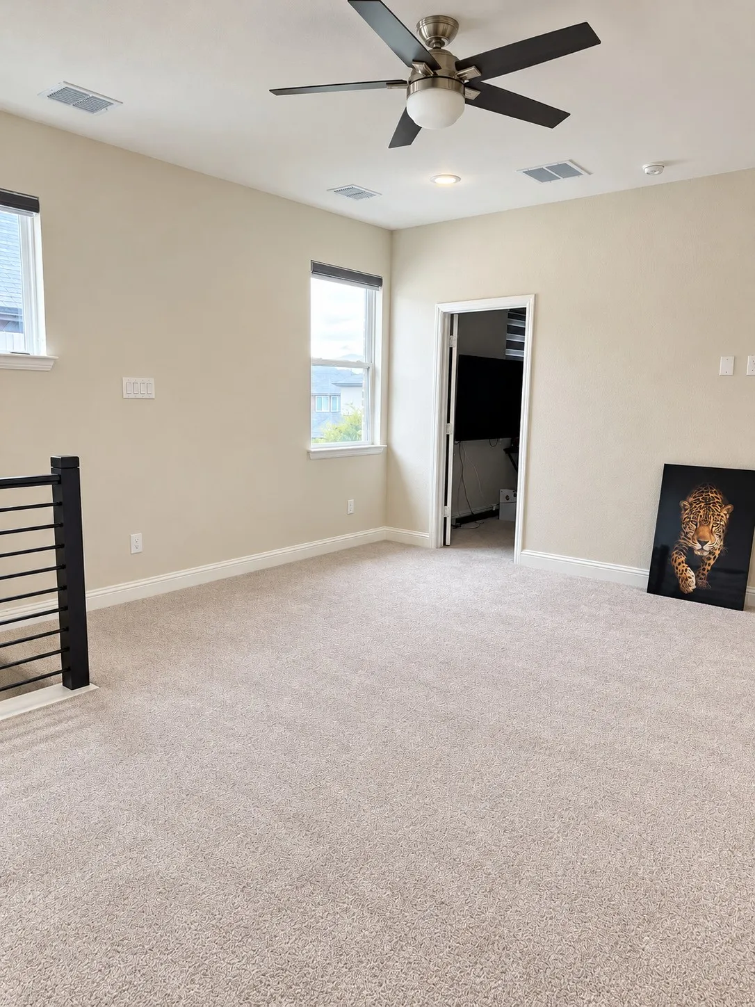 Plush carpeting, contemporary ceiling fan, recessed lighting, and modern window blinds