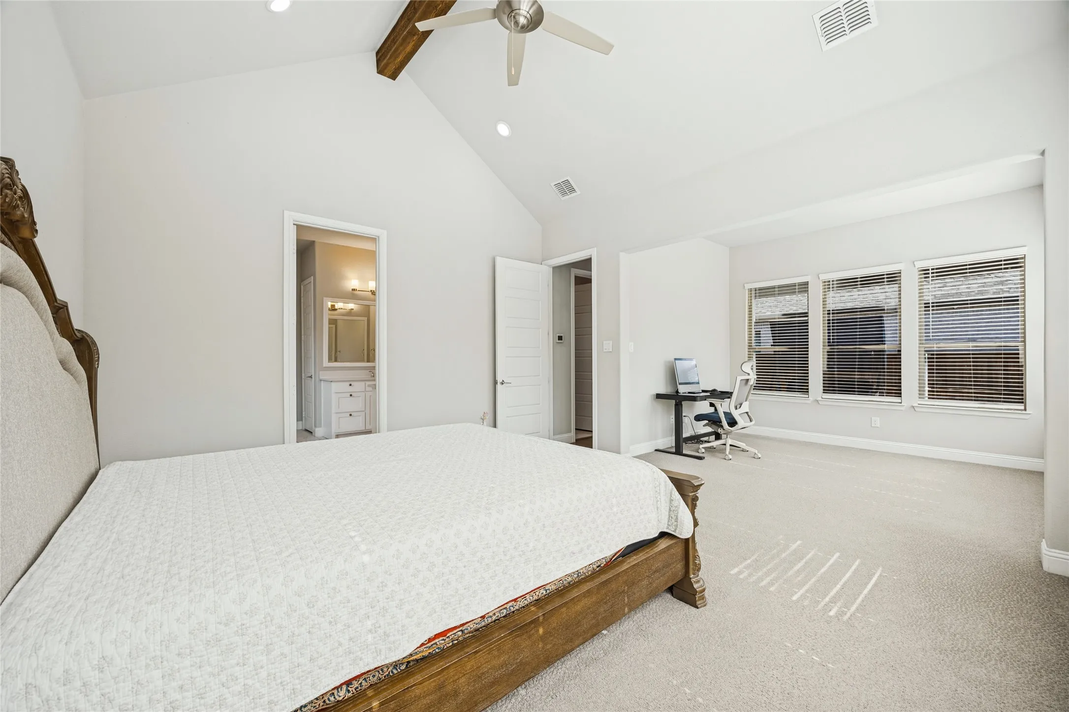 Vaulted ceiling with an exposed wood beam, recessed lighting, ceiling fan, and carpeted flooring
