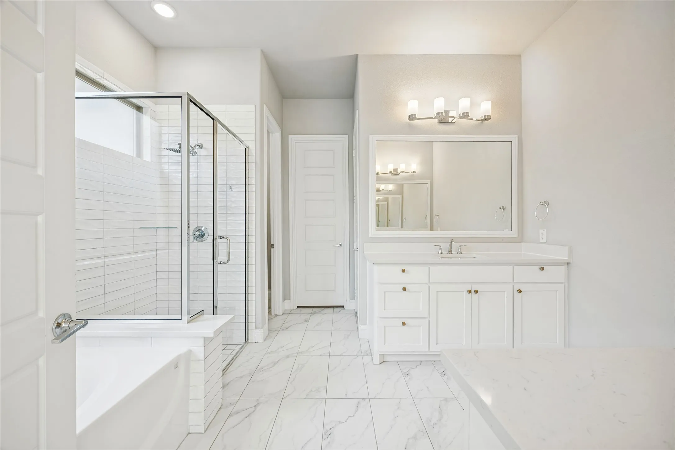 White vanity with an integrated sink and brushed nickel faucet
