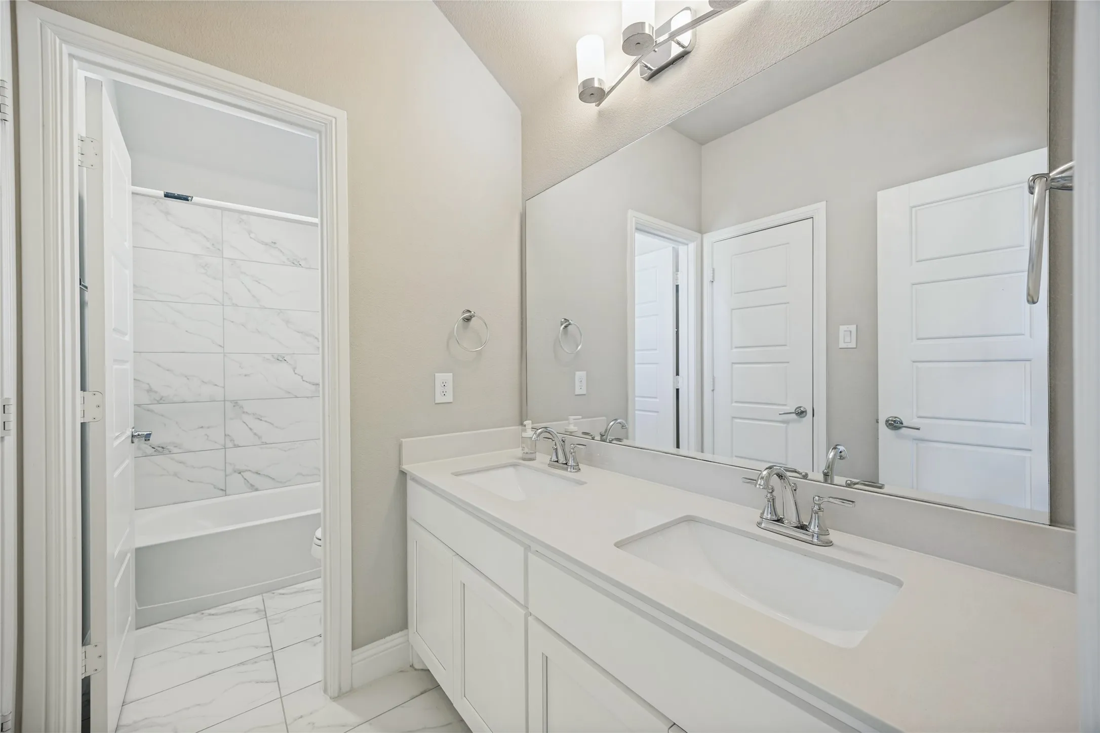 Dual vanity with undermount sinks and chrome fixtures