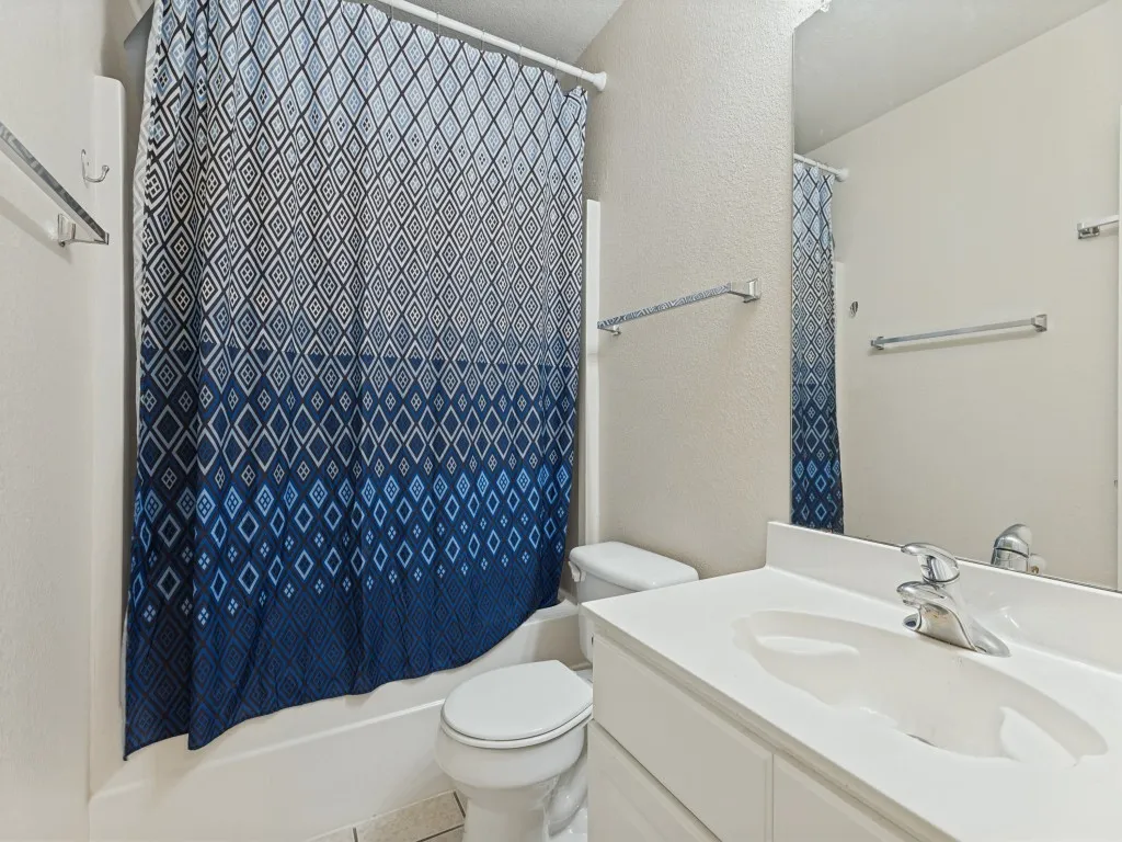 Bathroom with a single vanity, integrated sink, and white countertop