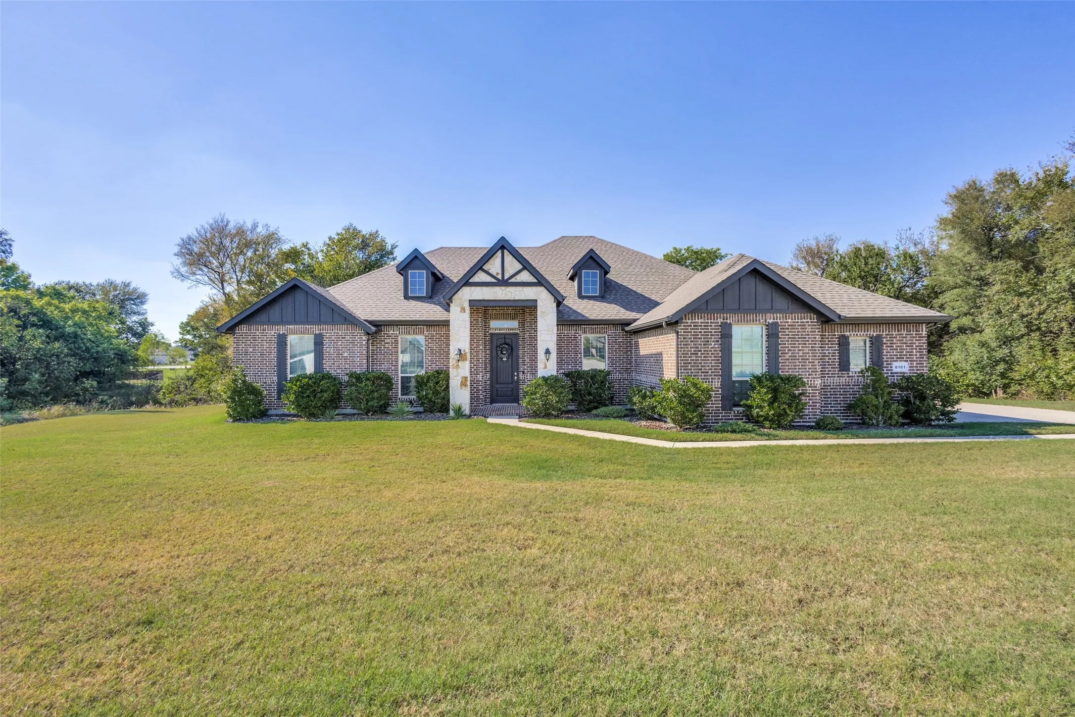 Brick exterior with accent siding and white stone details