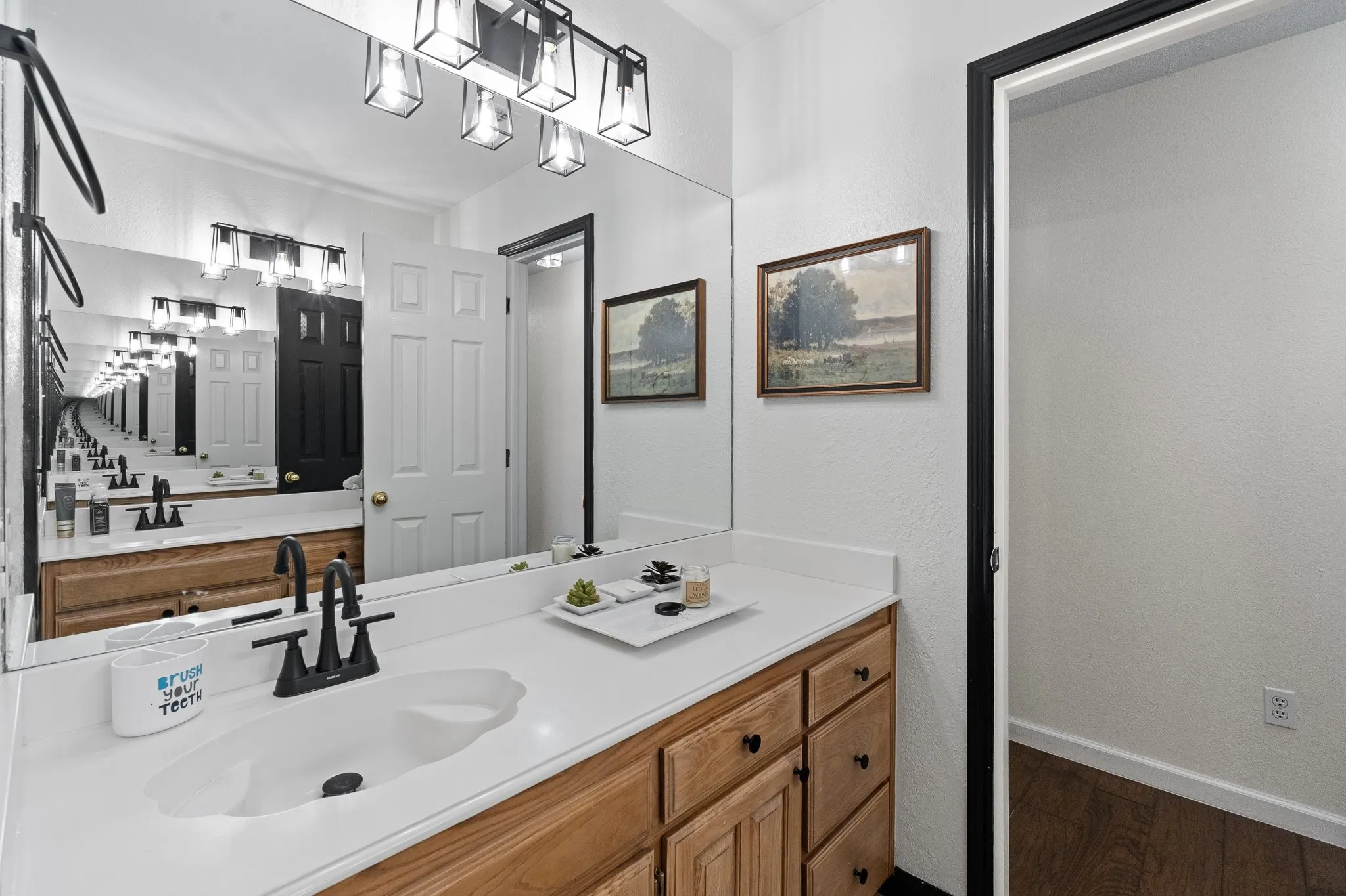 White countertop with integrated sink and matte black faucet