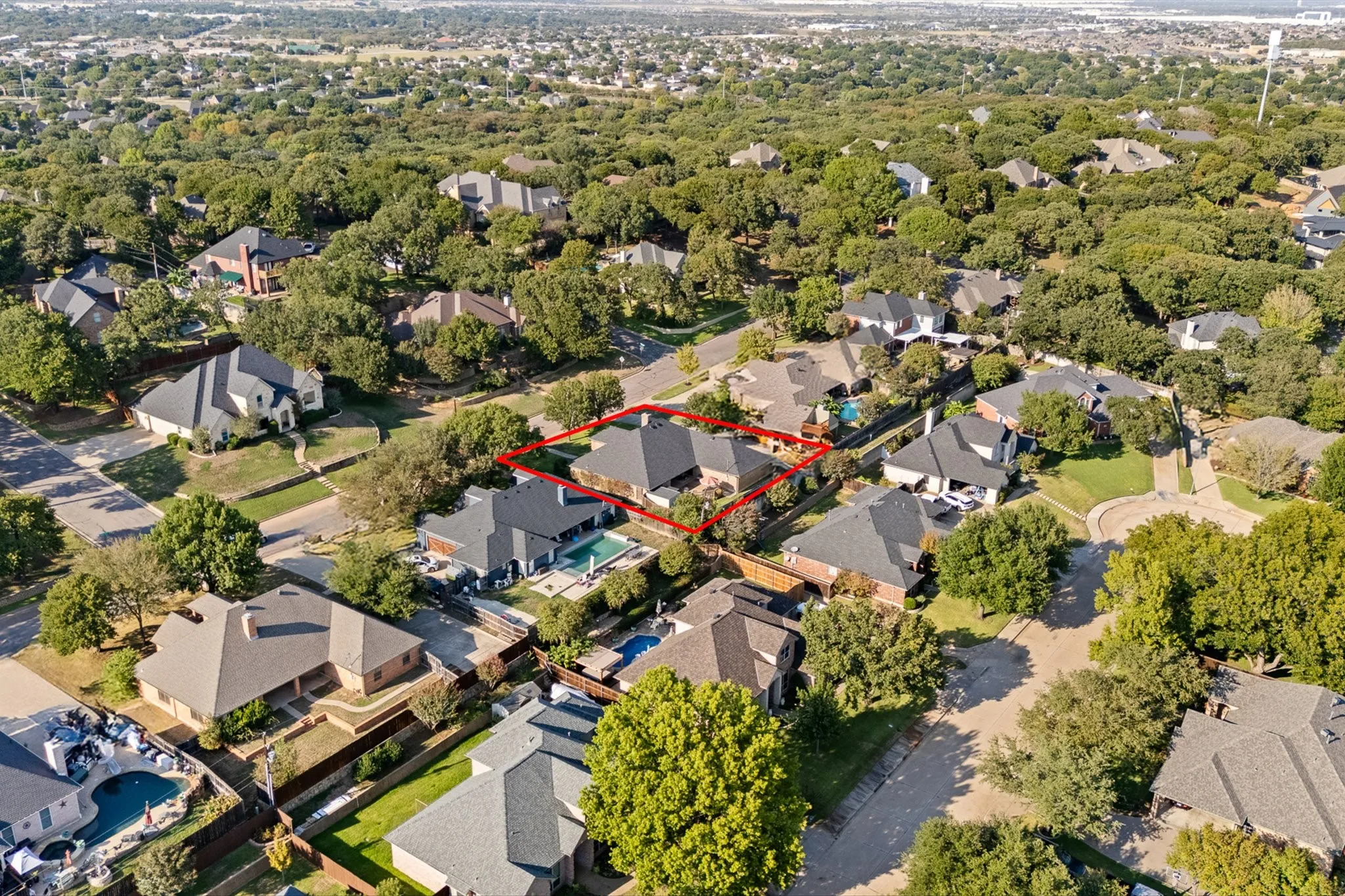 Expansive residential neighborhood featuring numerous mature trees and a manicured streetscape