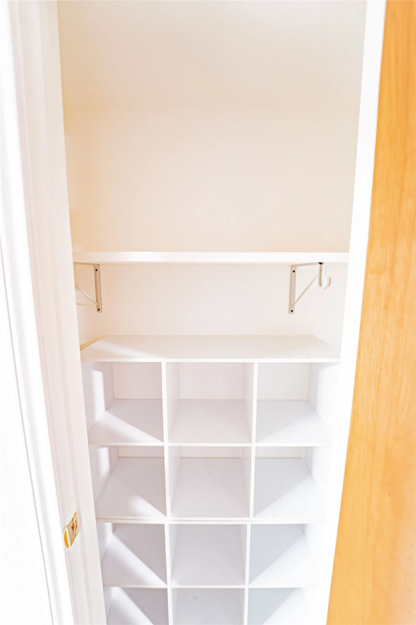 Integrated shelving system featuring cubbies and an upper shelf