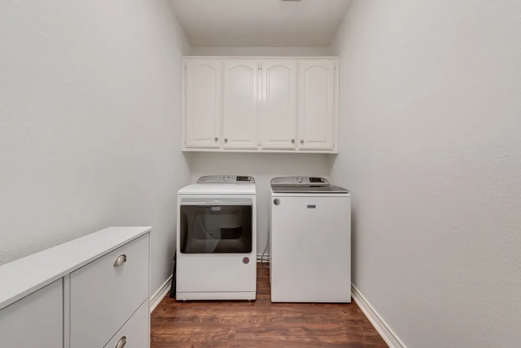 Large laundry room with built in shelves through to 3 car garage.