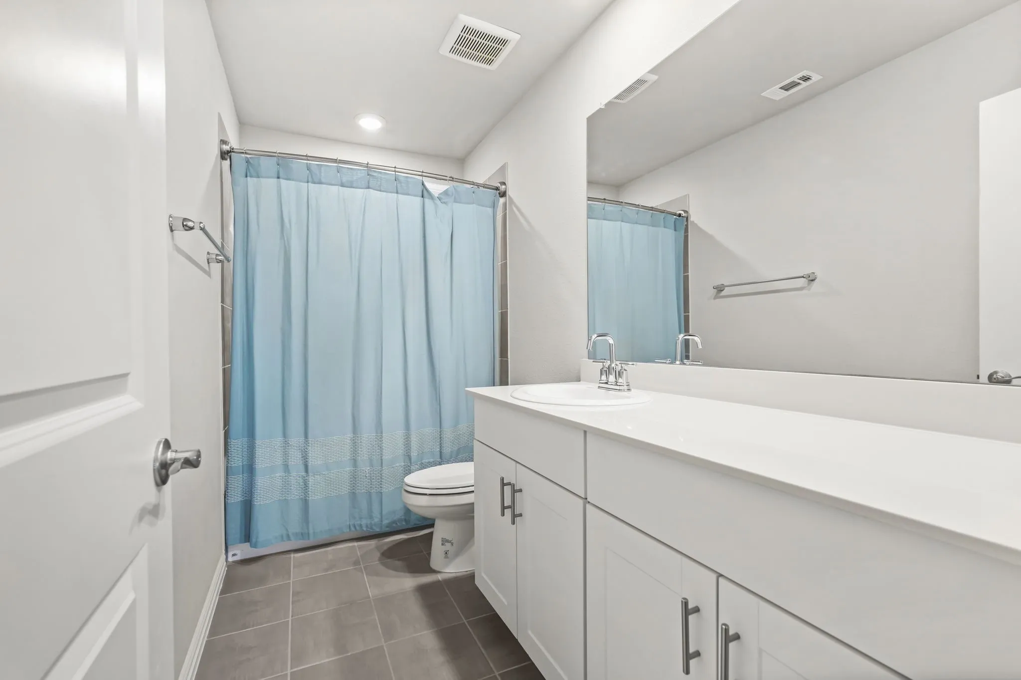 White single-sink vanity with white countertop, chrome faucet, and under-sink cabinetry with bar pulls