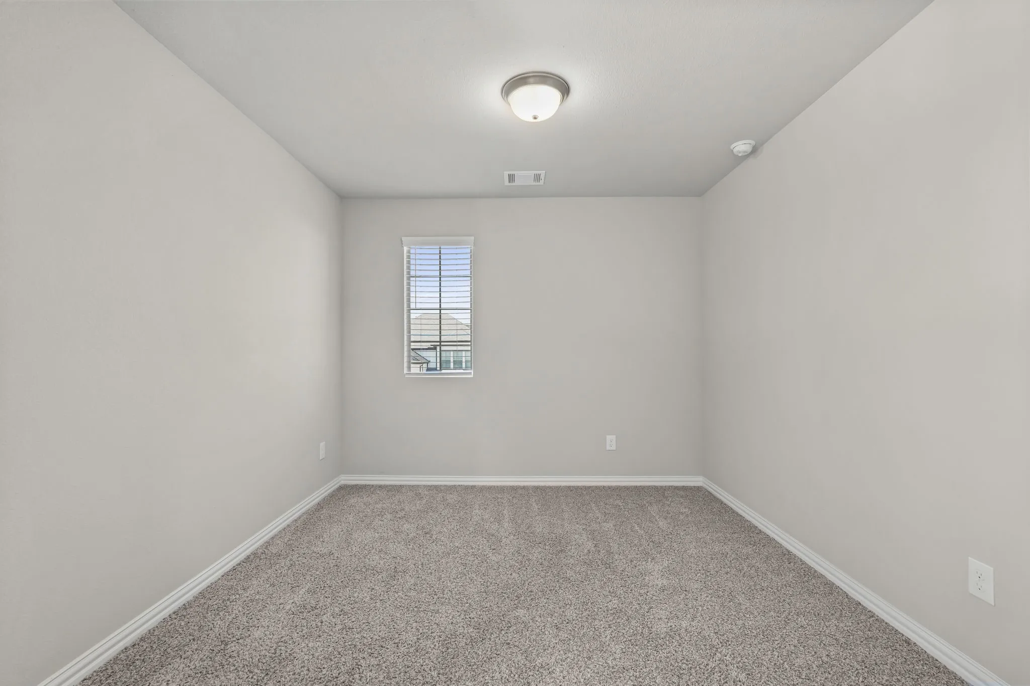 Neutral paint palette, single window with blinds, wall-to-wall carpeting, and a flush mount ceiling light fixture